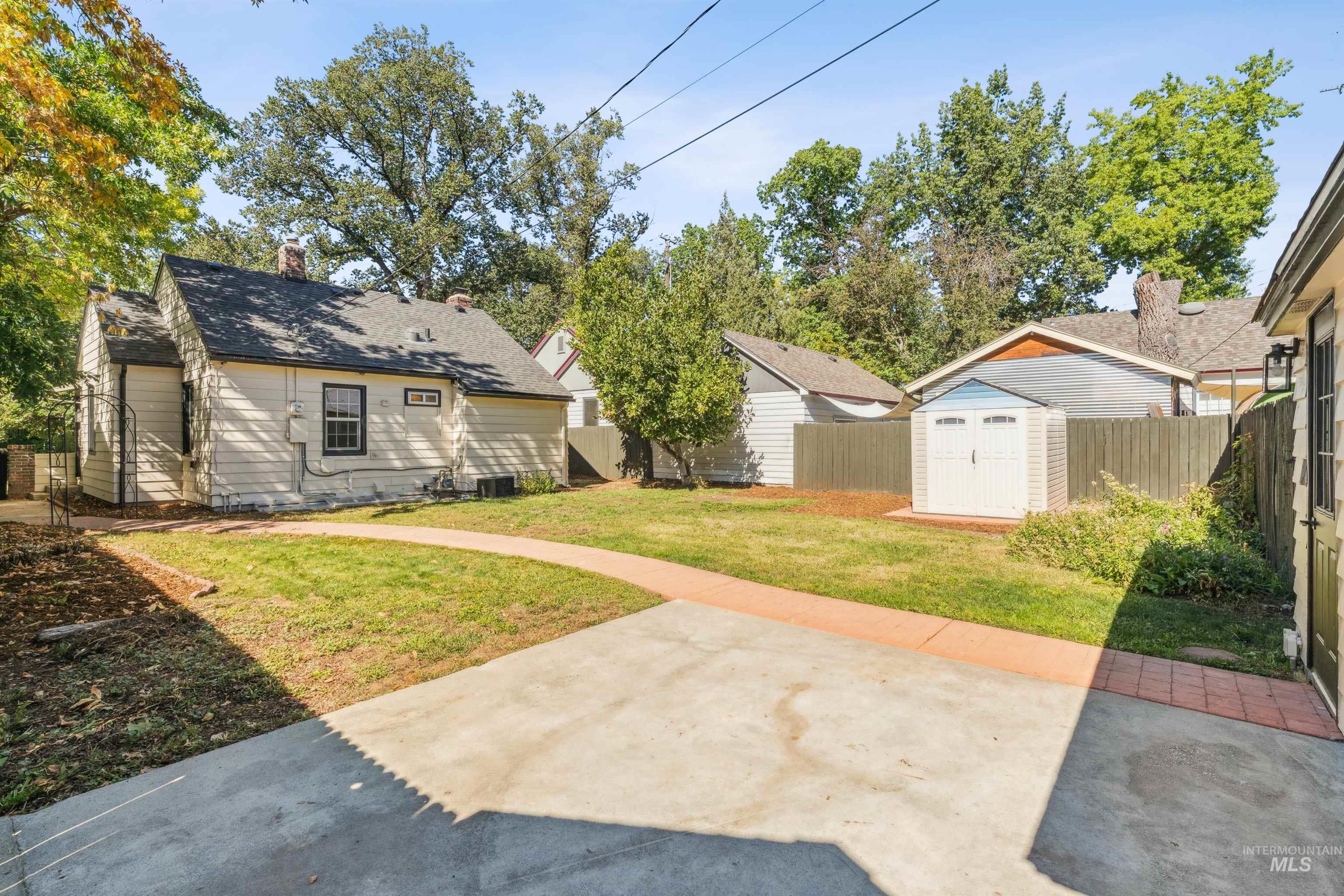 Fenced backyard with a storage unit