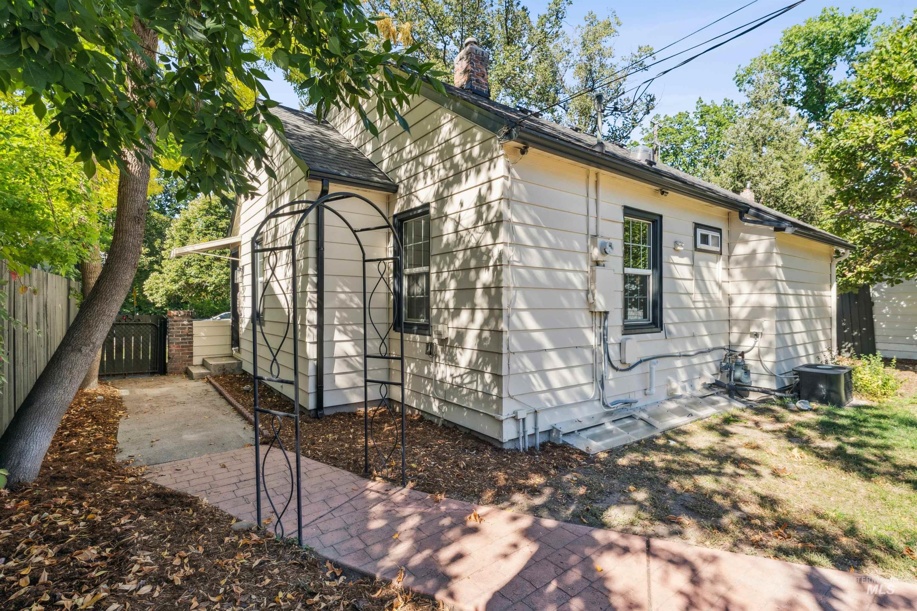 View of home's exterior featuring a chimney and a central AC unit