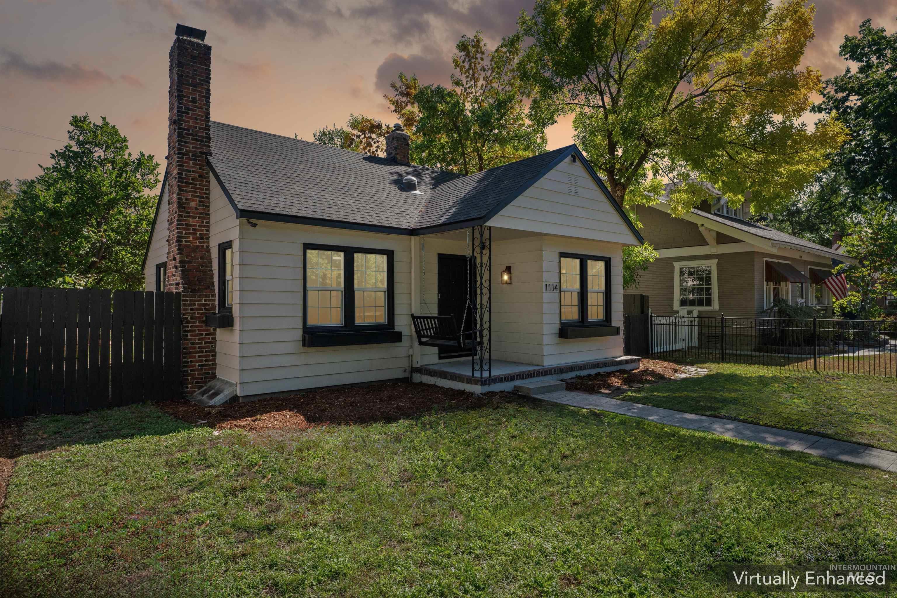 Bungalow-style house featuring a chimney and a shingled roof