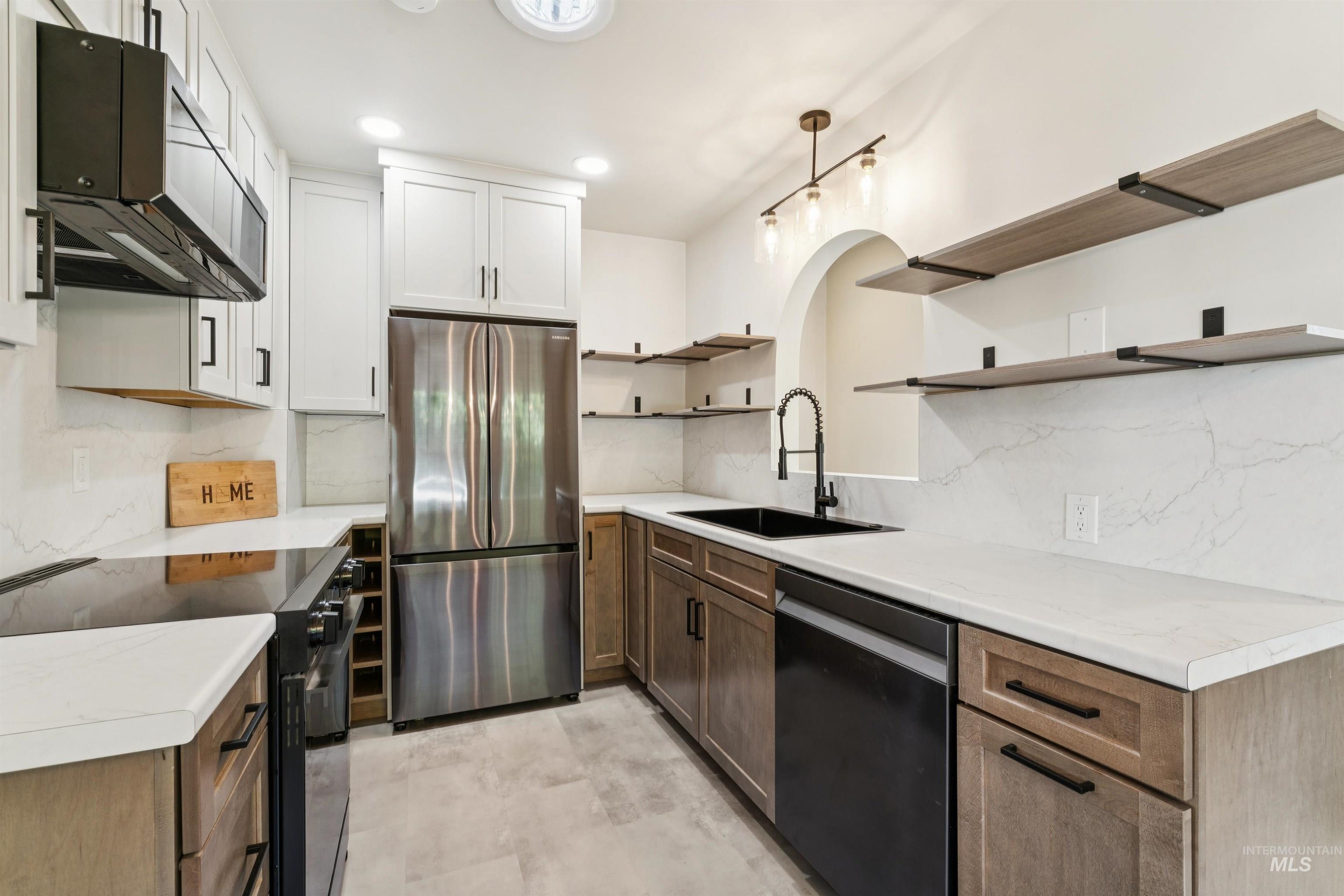 Kitchen with black appliances, open shelves, light countertops, tasteful backsplash, and recessed lighting
