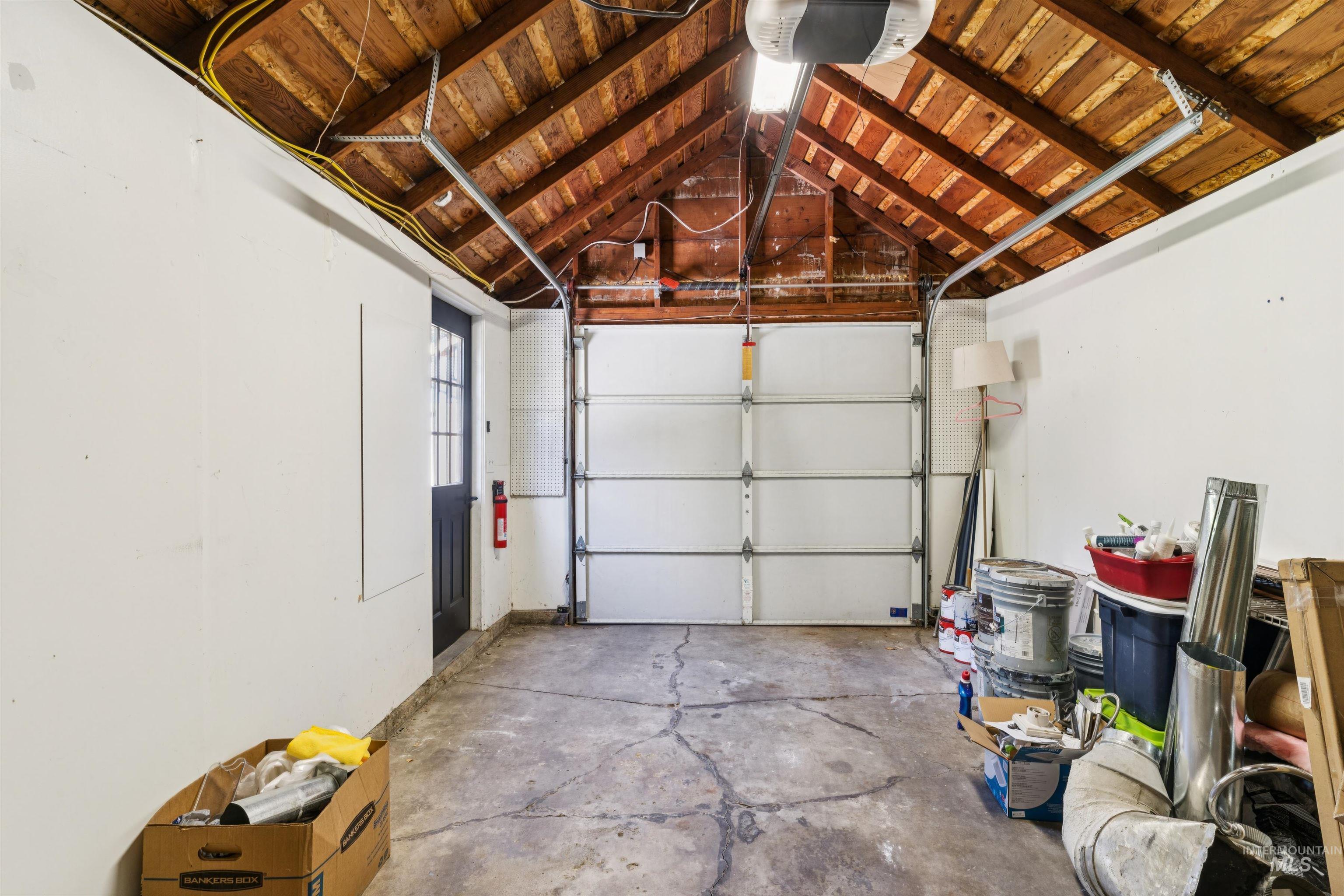Garage featuring wood ceiling and a garage door opener