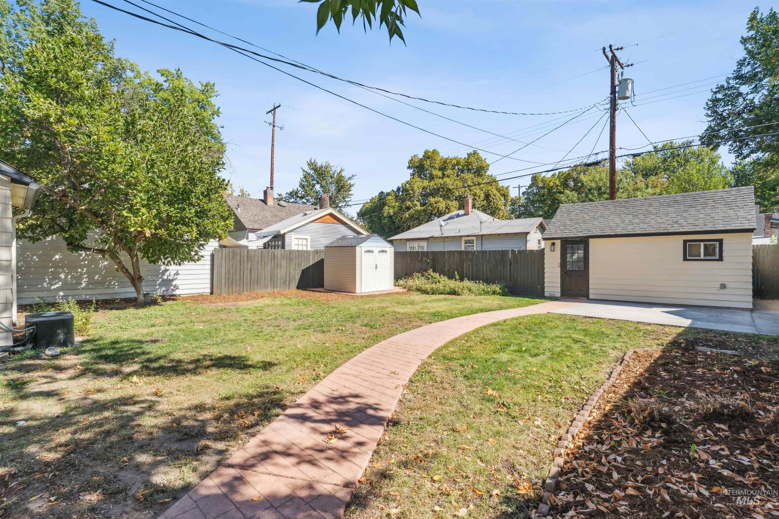 Fenced backyard with a storage unit