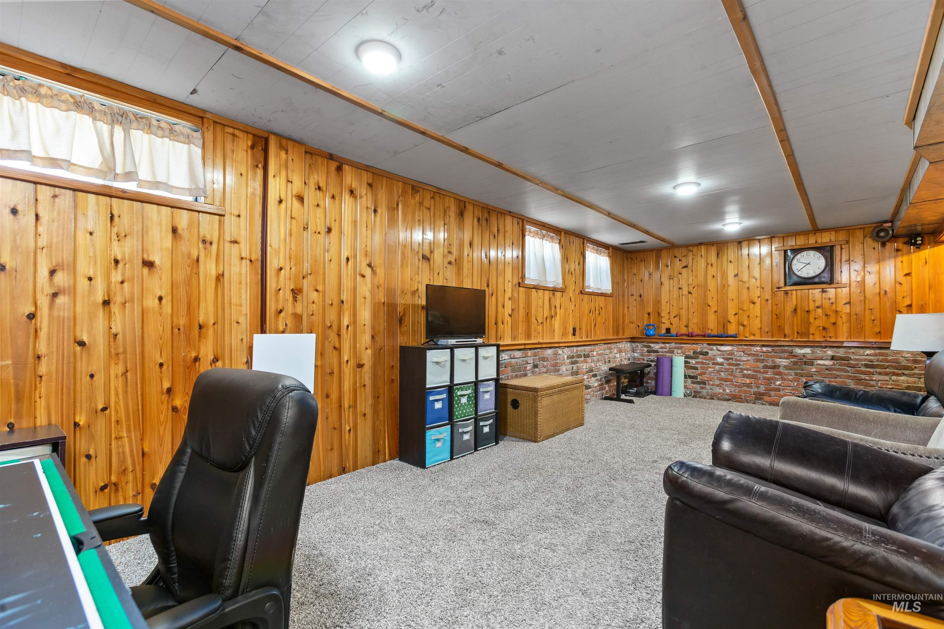 Carpeted office space with wooden walls