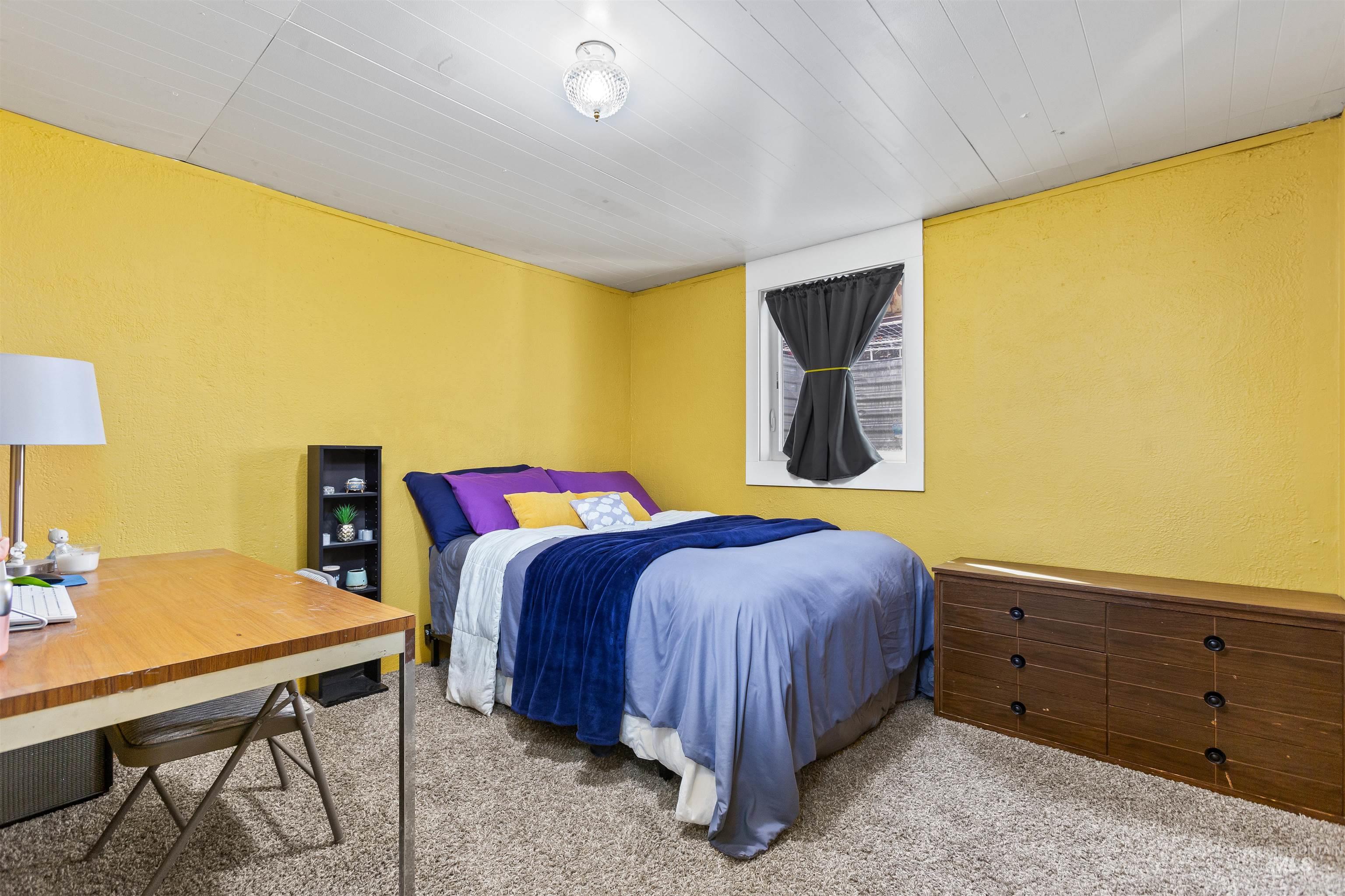 Carpeted bedroom with a textured wall