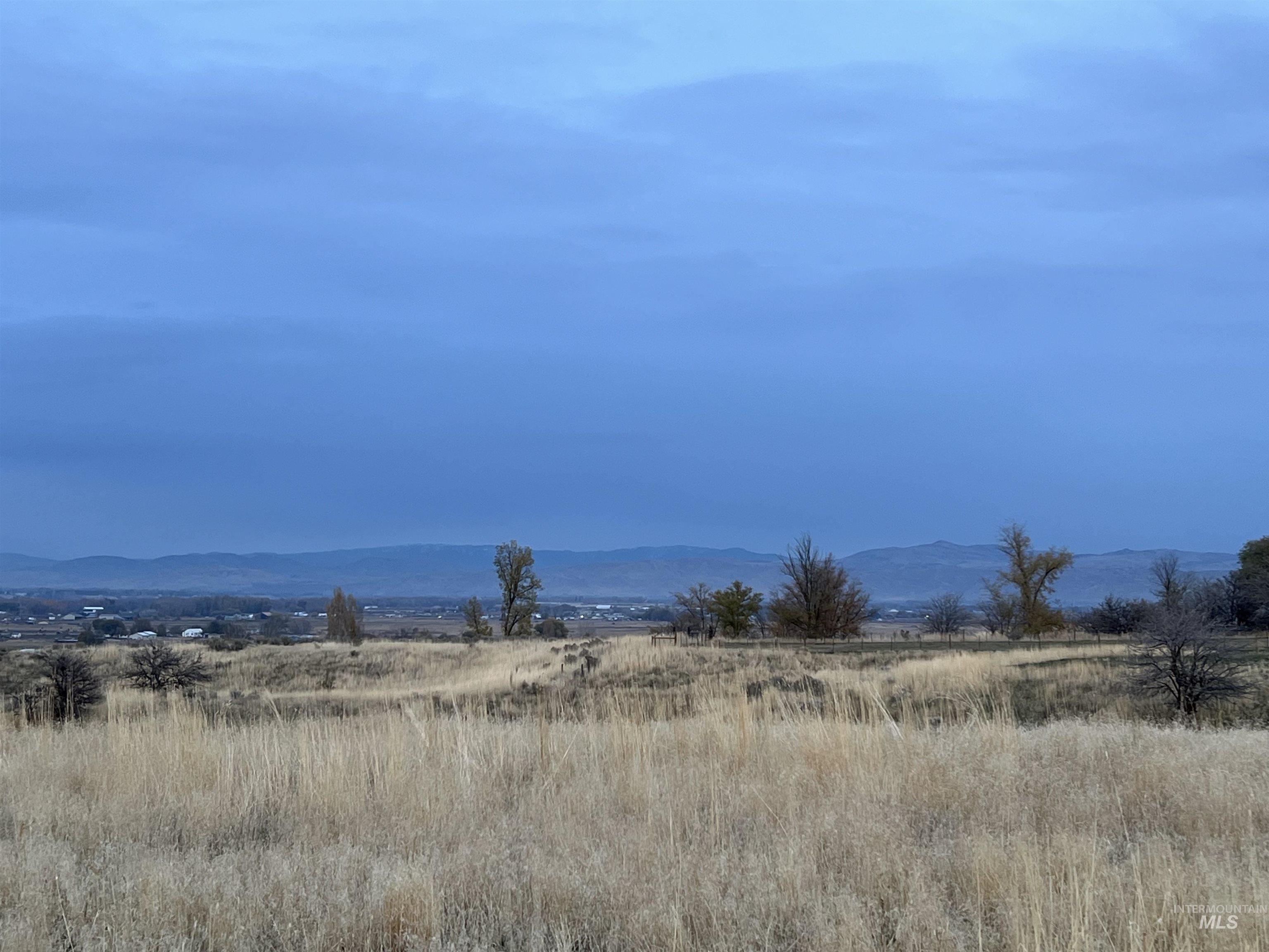 View of mountain backdrop with rural landscape