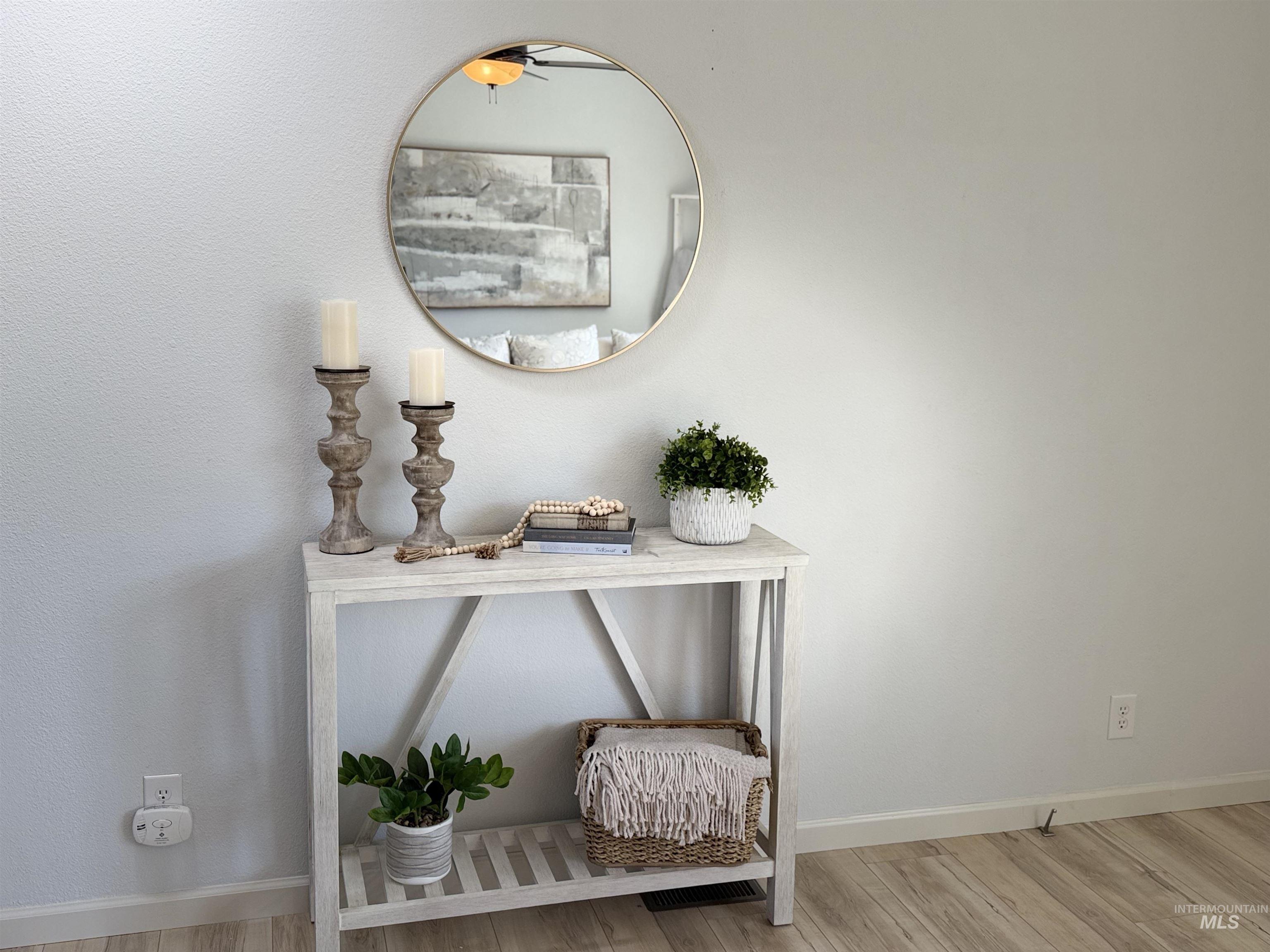 Light wood-finish flooring complements the neutral wall color