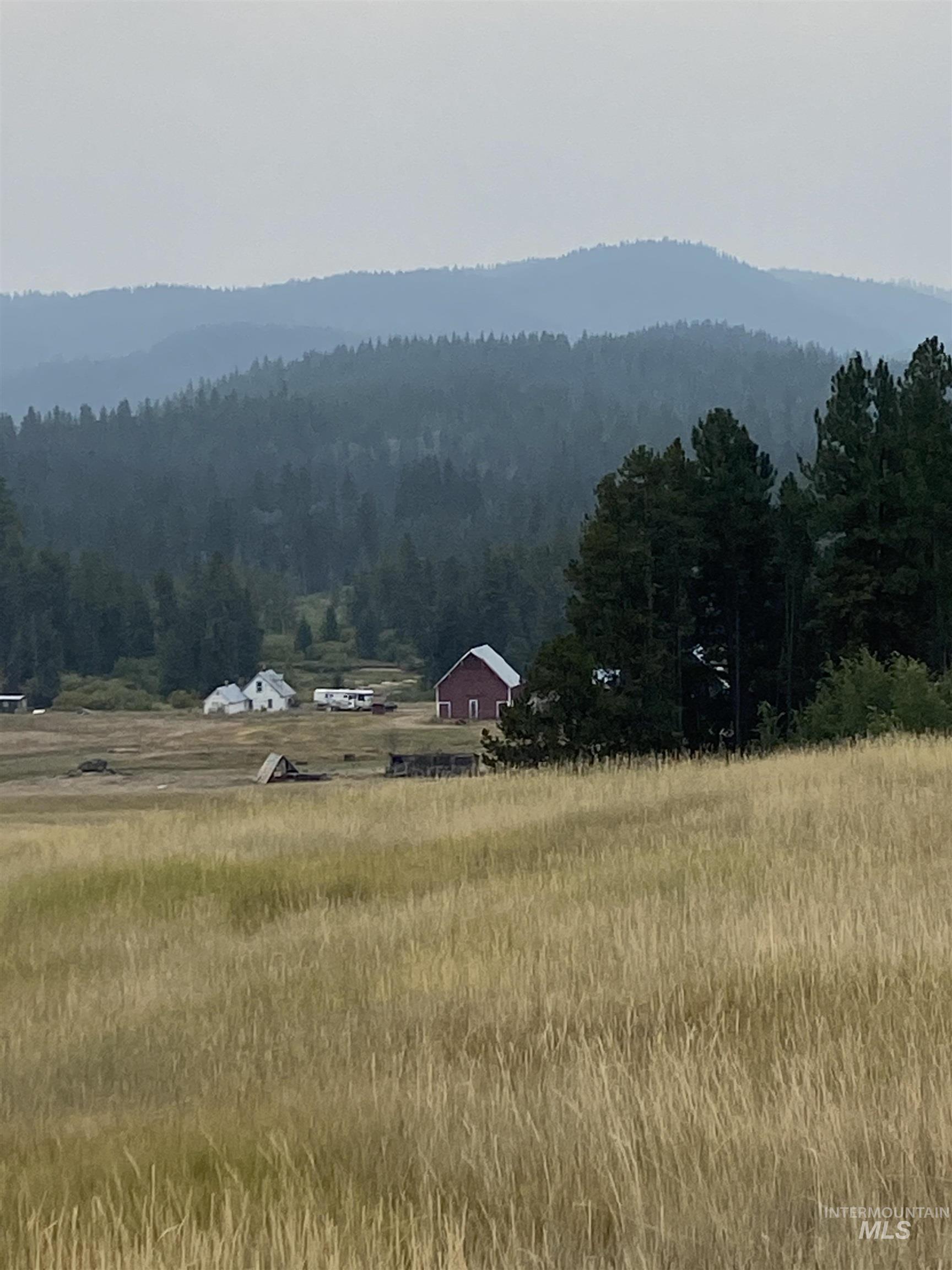 View of mountain background featuring a forest and rural landscape