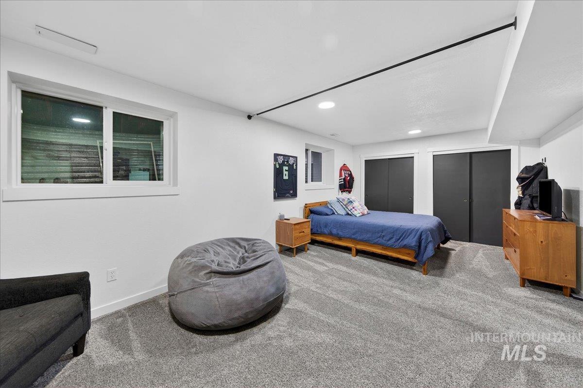 Bedroom with multiple closets, carpet floors, and recessed lighting