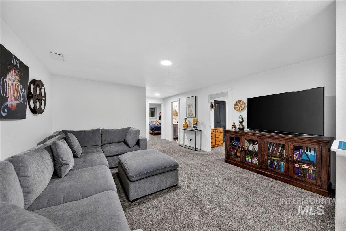 Living room featuring carpet flooring and recessed lighting