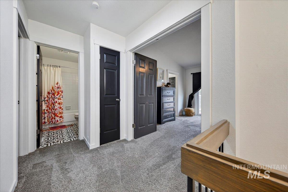 Hallway featuring carpet floors