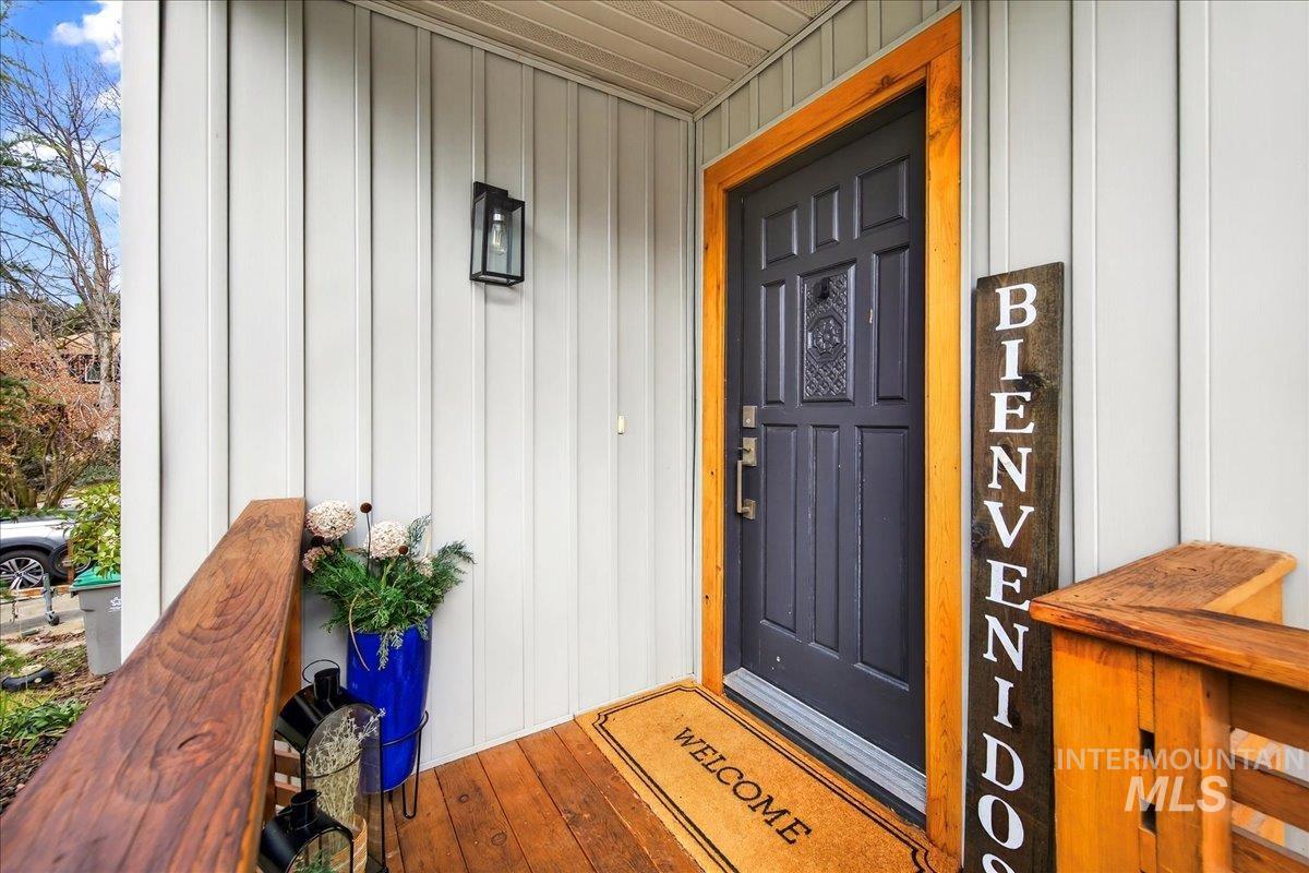 Property entrance with board and batten siding and covered porch
