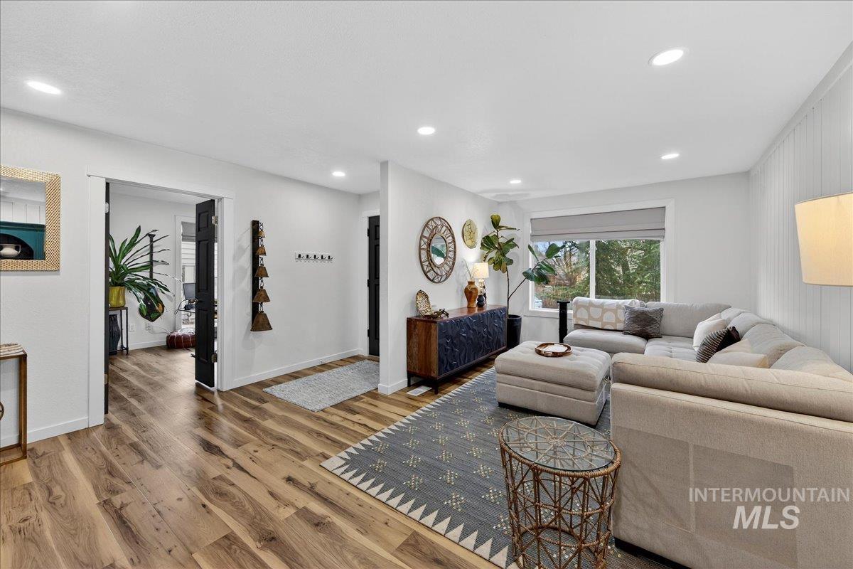 Living area with wood finished floors and recessed lighting