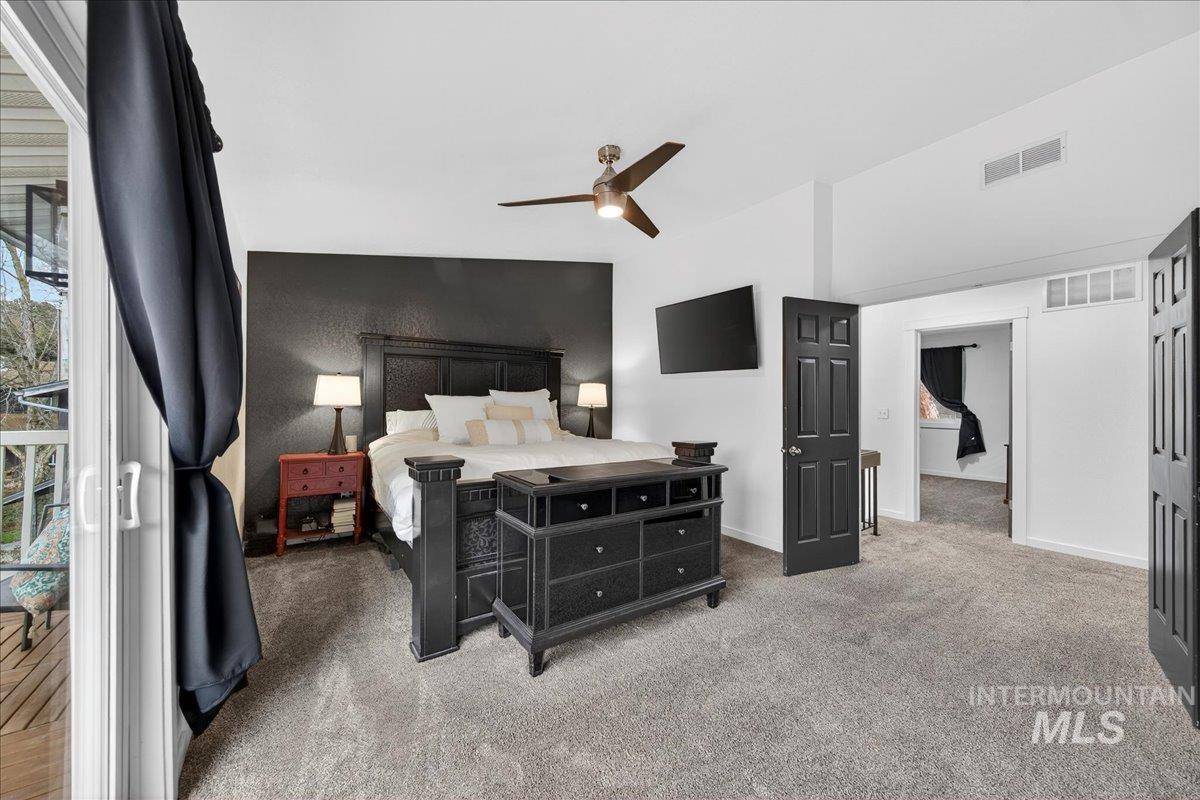 Bedroom with light carpet and a ceiling fan