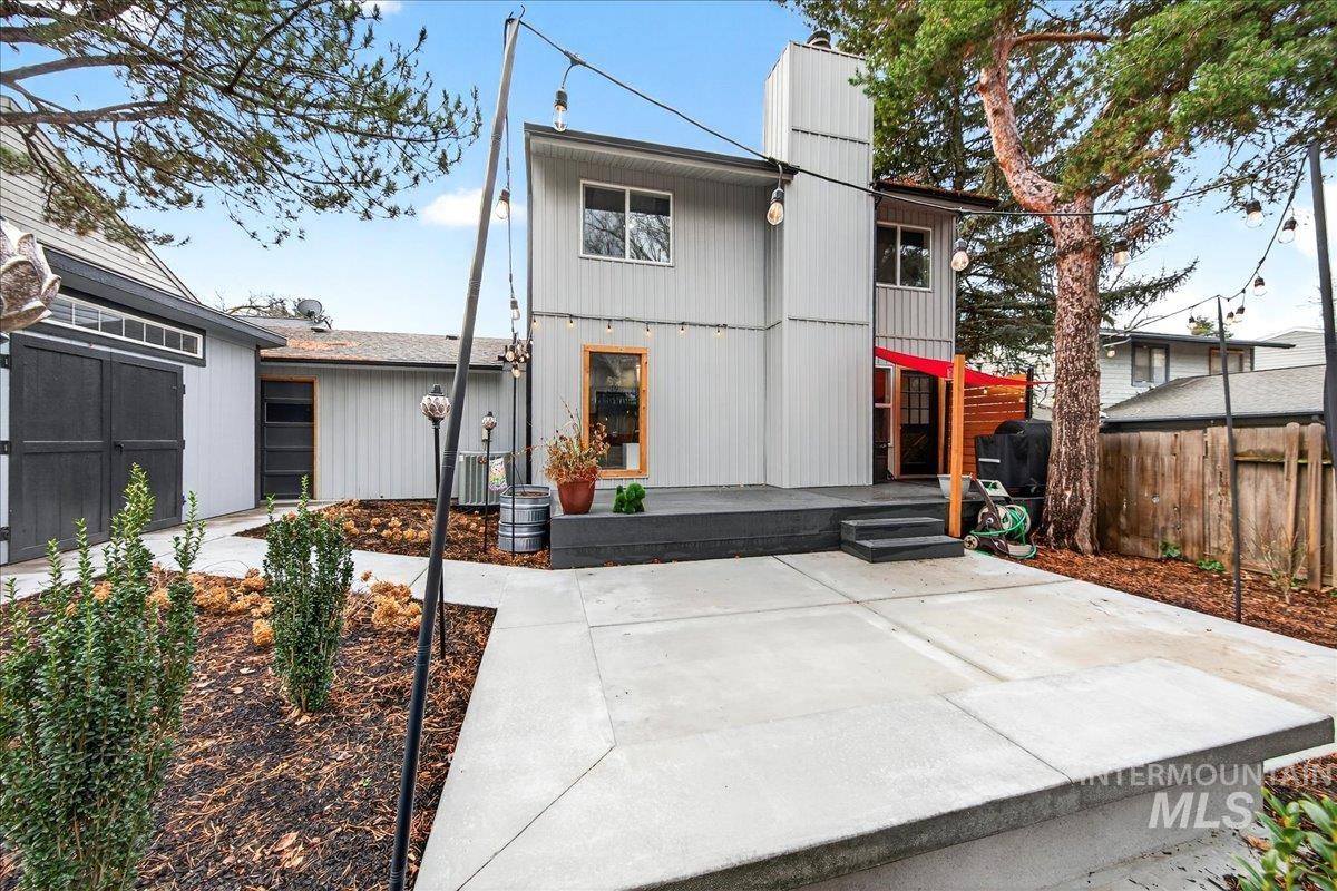 Rear view of house with a chimney and a deck