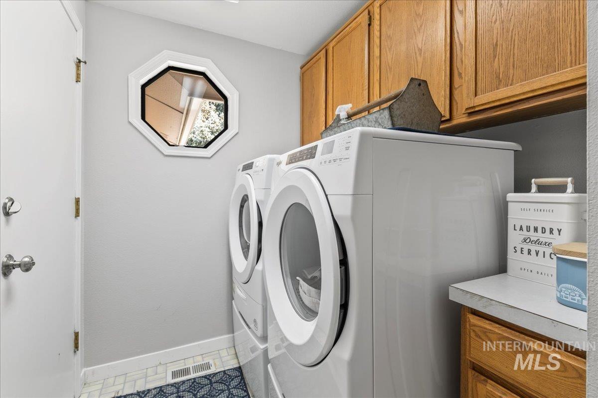 Laundry room with cabinet space and washing machine and clothes dryer