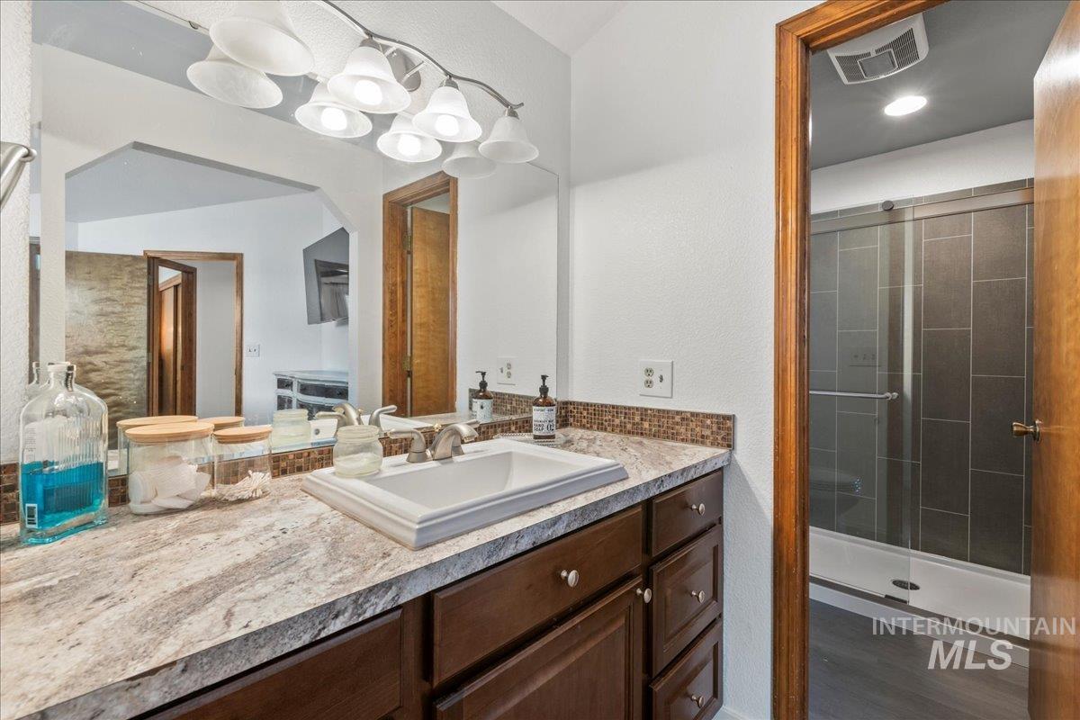 Full bathroom featuring vanity and a stall shower