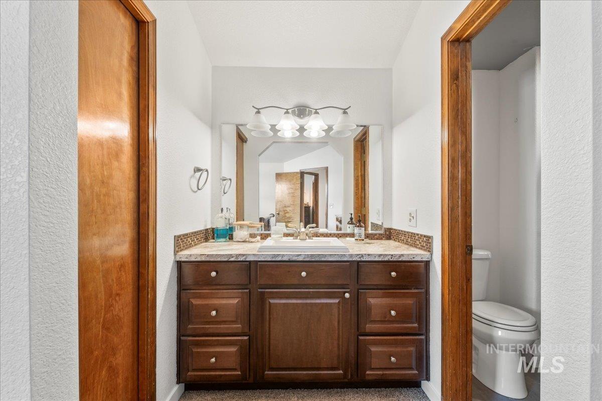 Bathroom with double vanity and toilet