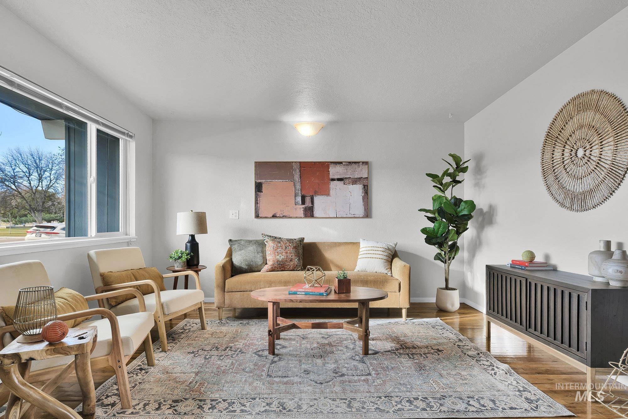 Living room with wood finished floors and a textured ceiling