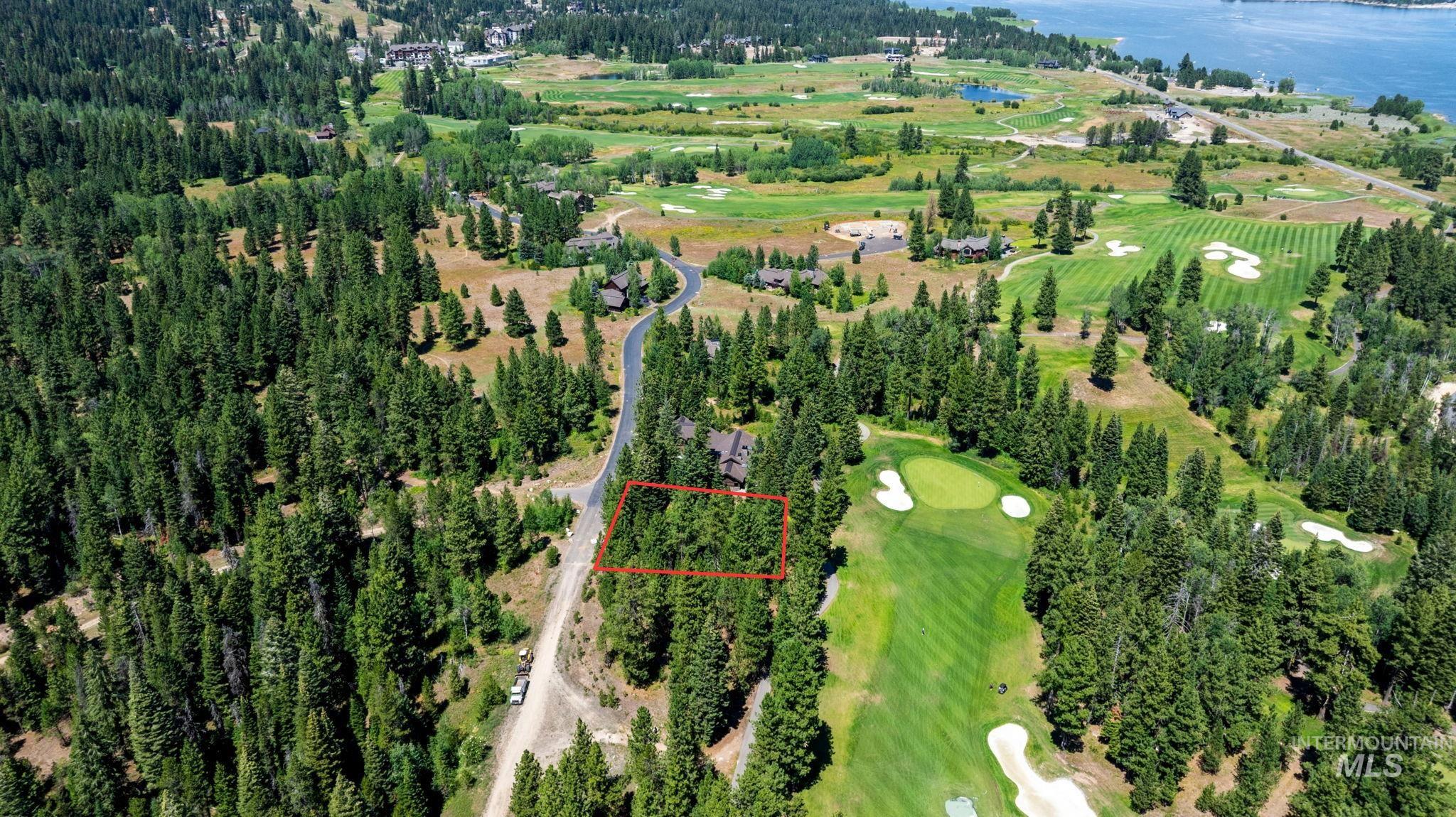 Aerial overview of property's location with a golf course and property parcel outlined