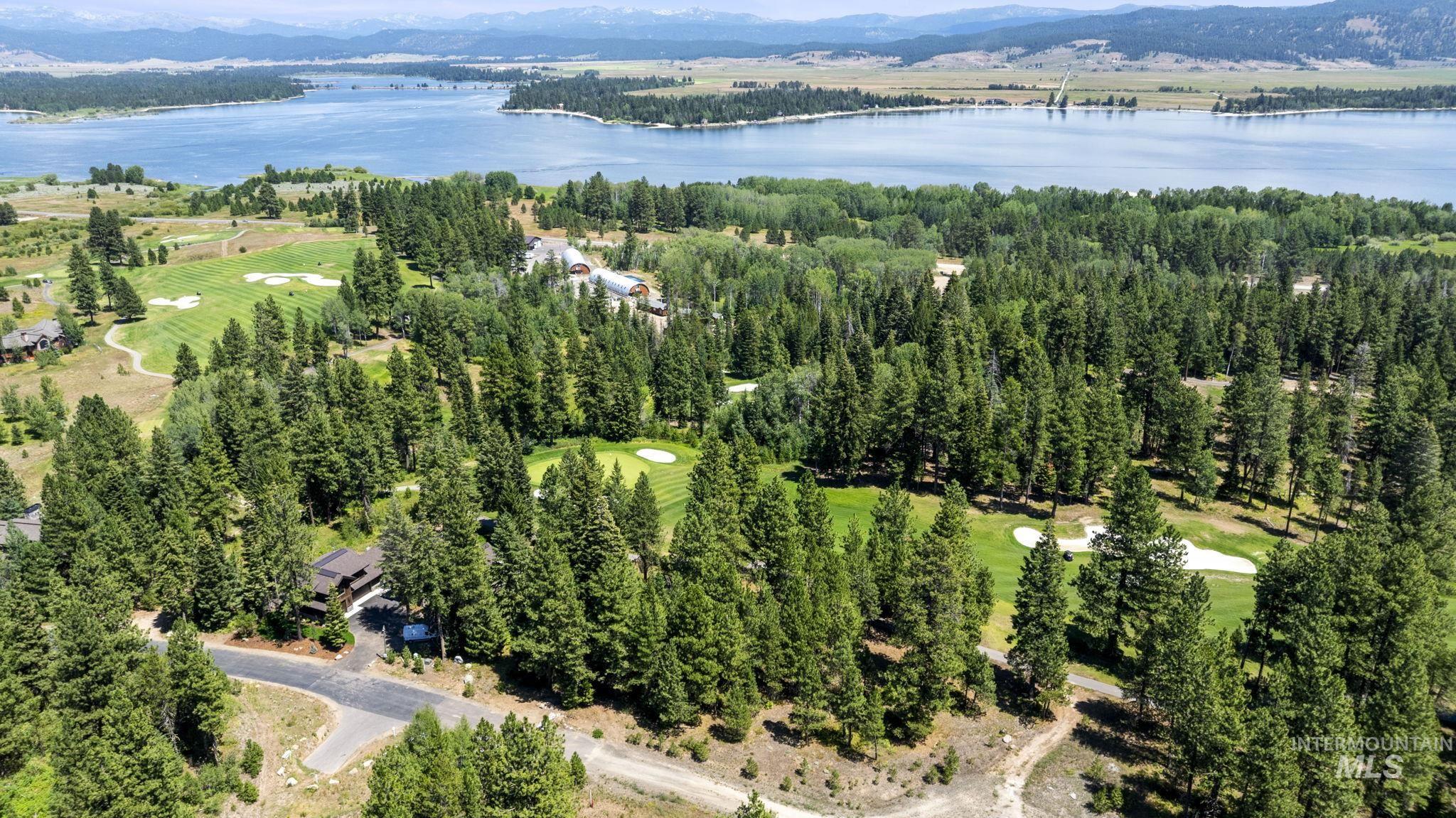 View of property location featuring a water and mountain view and a local golf course