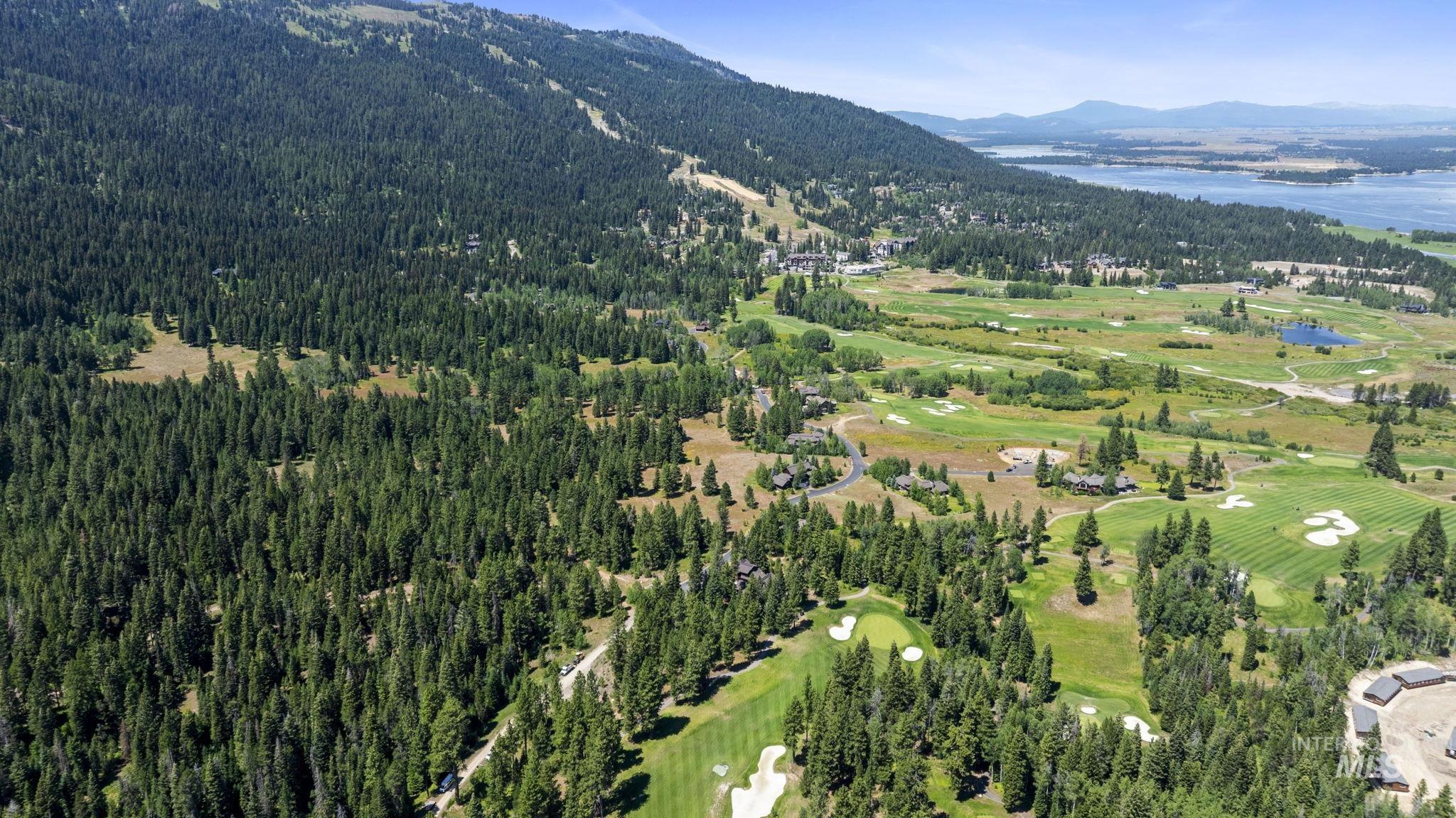 Aerial view of property's location with a water and mountain view and a golf club