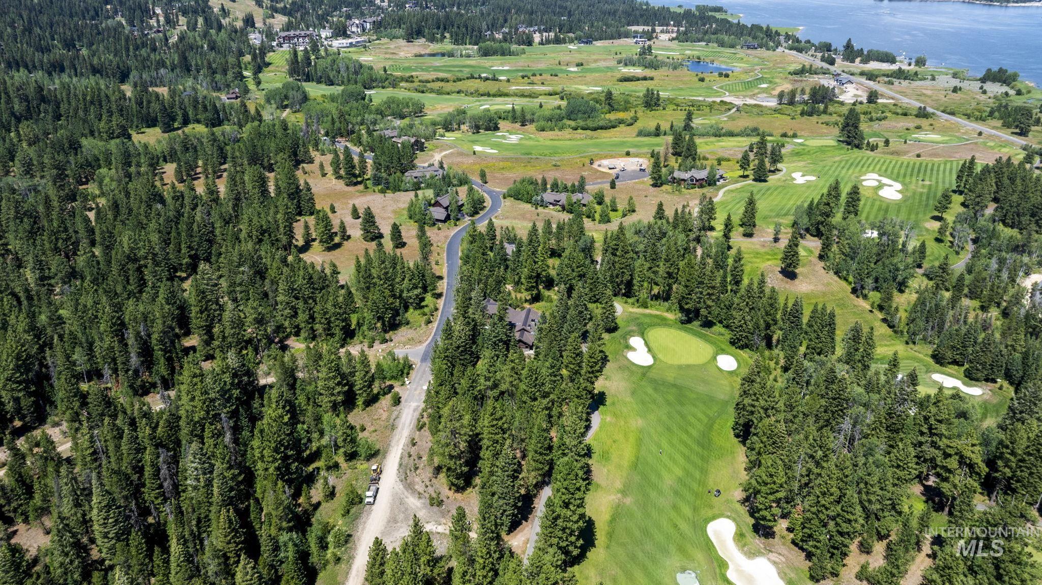 Aerial overview of property's location featuring a local golf course and a nearby body of water