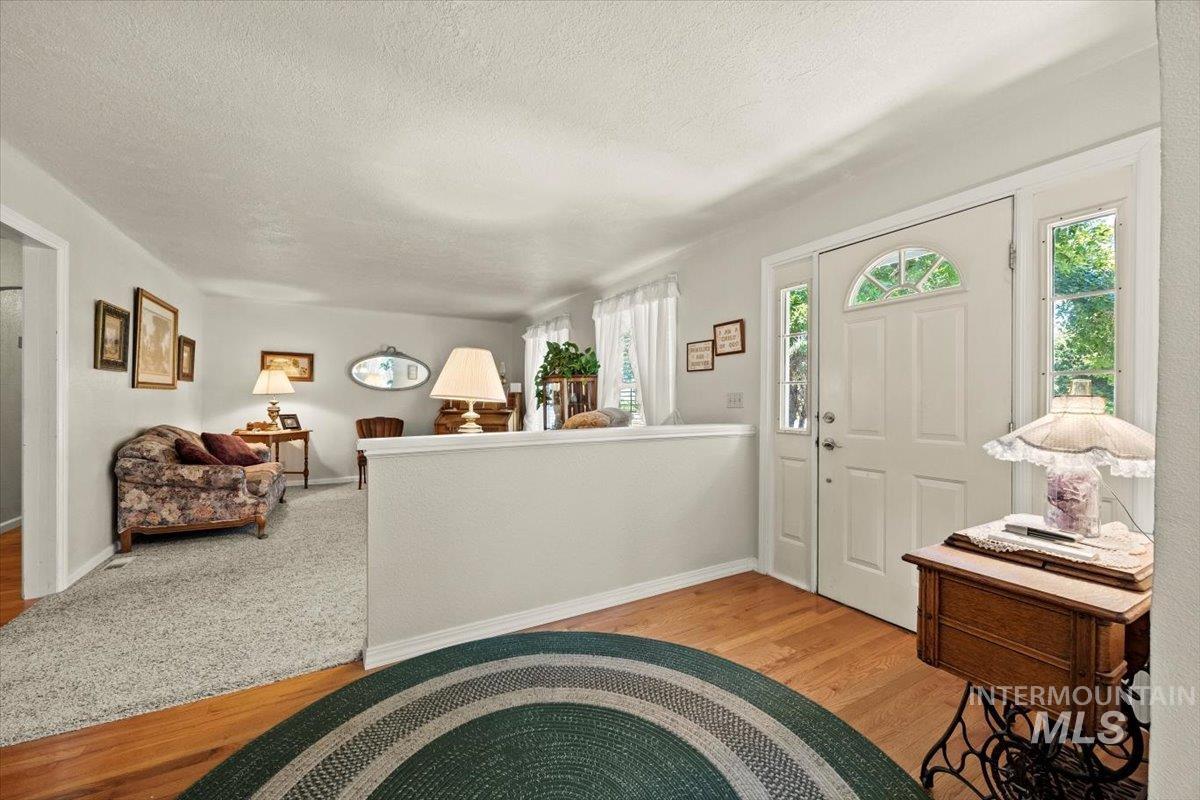 Foyer with wood finished floors and a textured ceiling