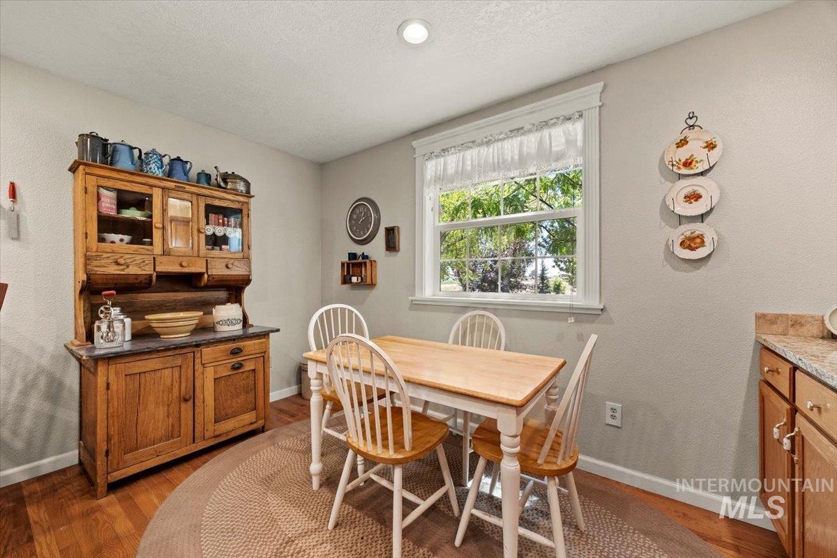 Dining area with light wood-style flooring and baseboards