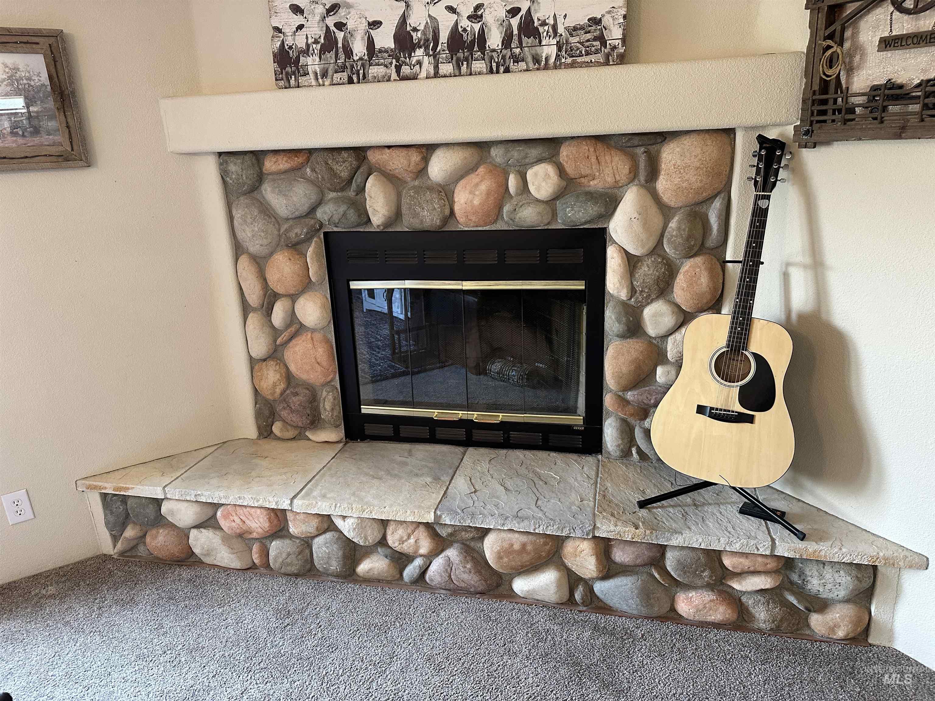 Detailed view of a fireplace and carpet floors