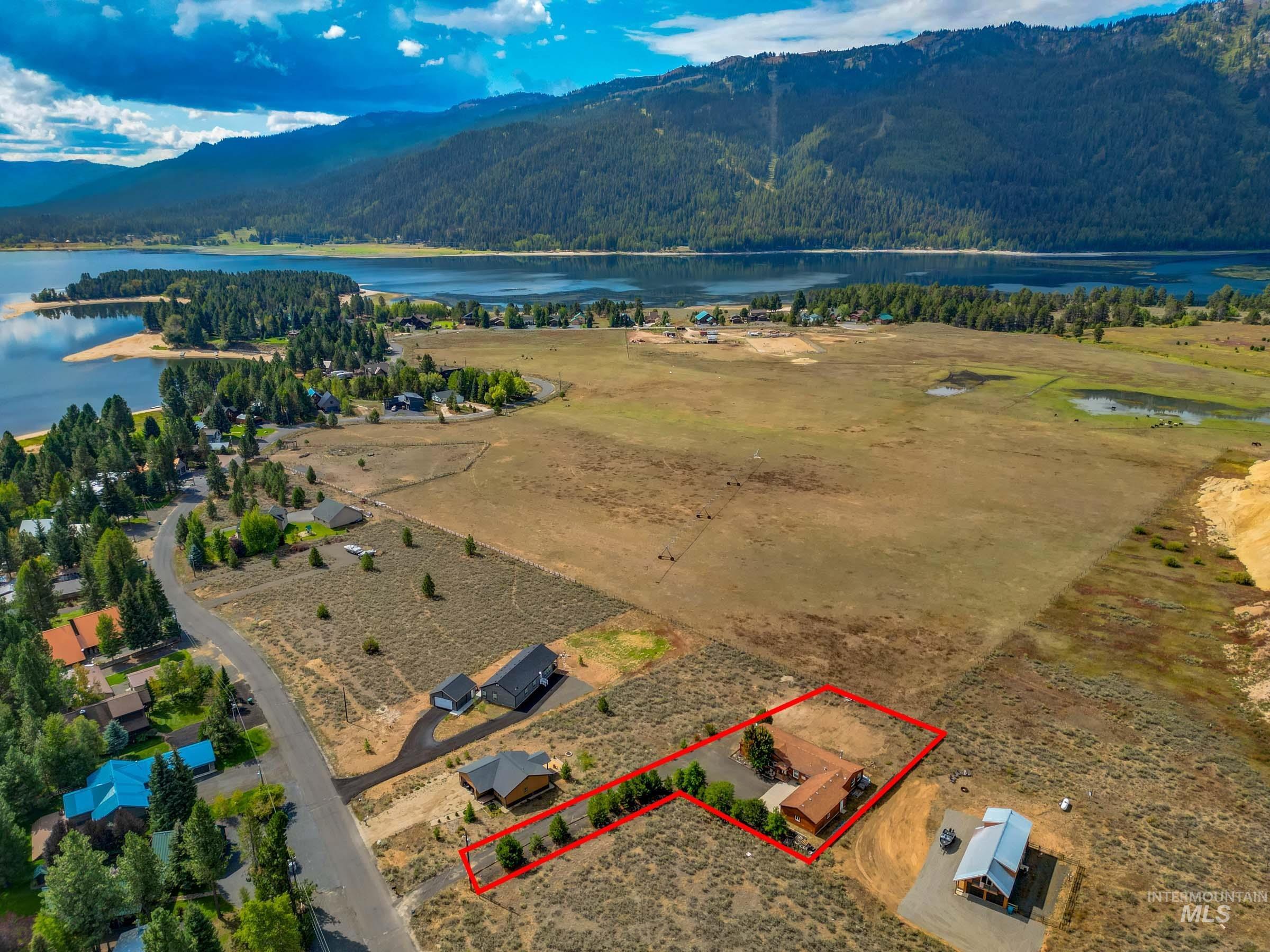 Aerial view of property's location with property parcel outlined and a water and mountain view