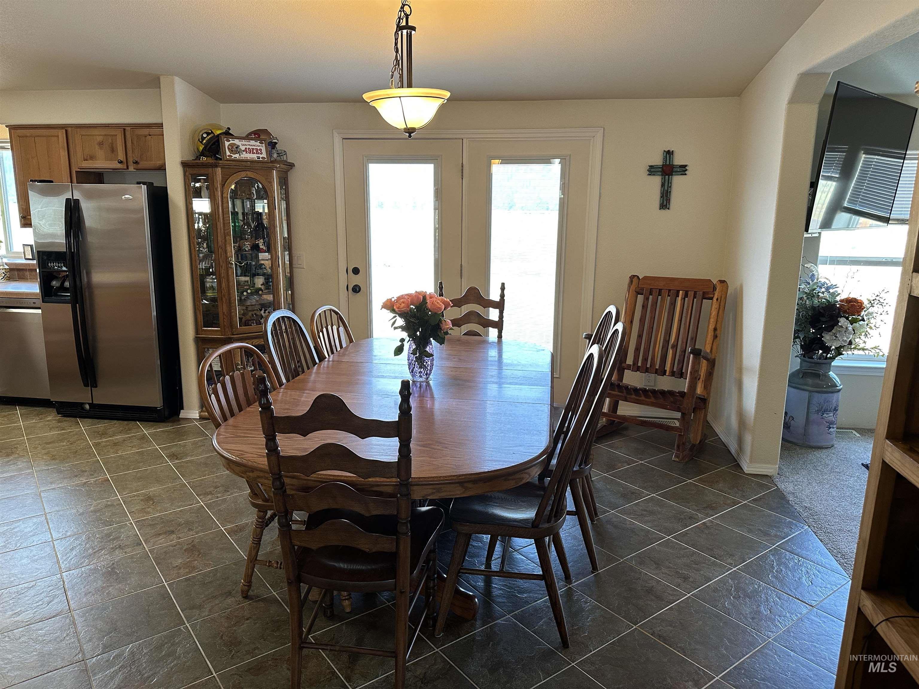 Dining room featuring french doors and baseboards