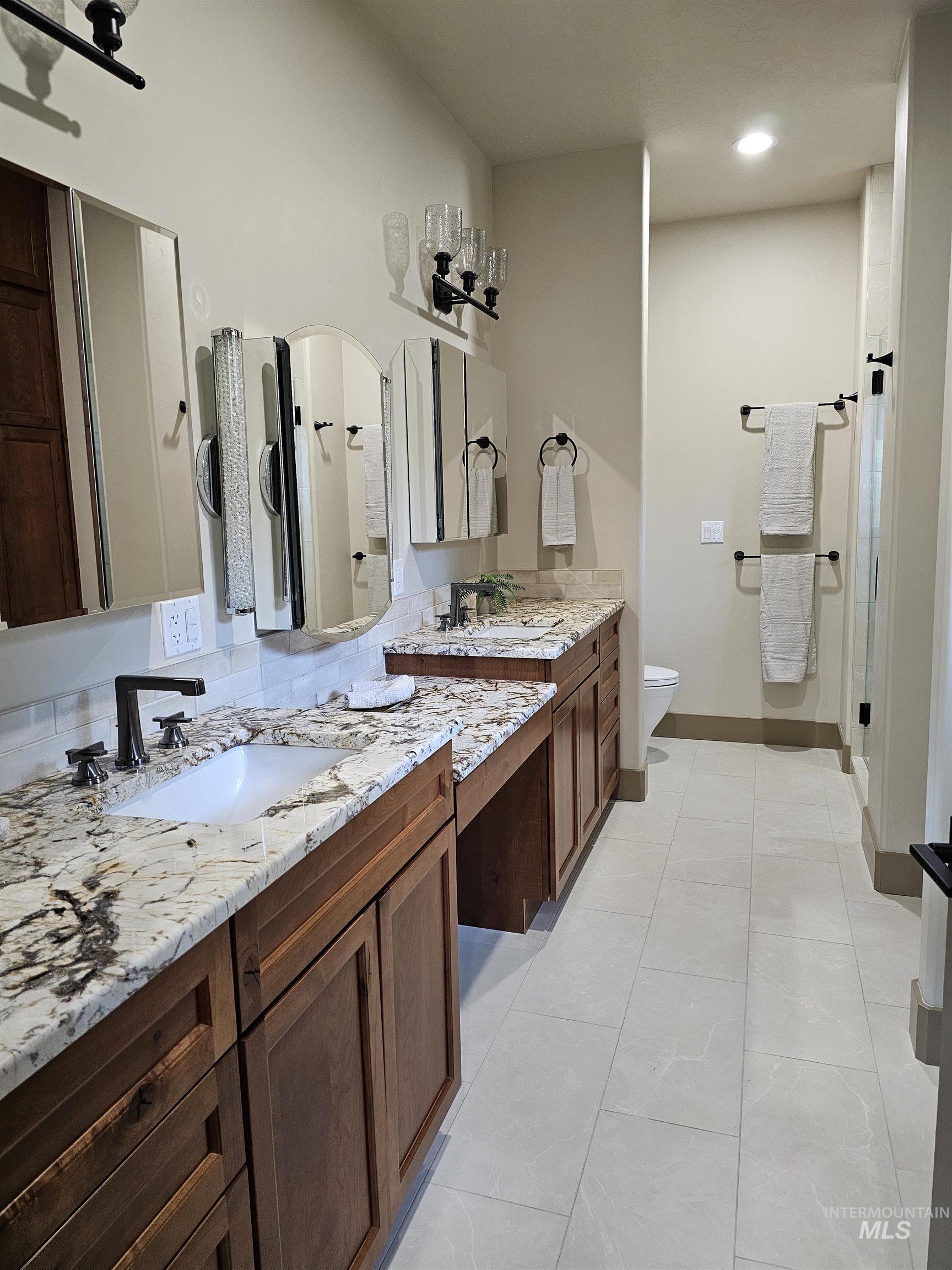 Bathroom with dual sinks and a vanity area.