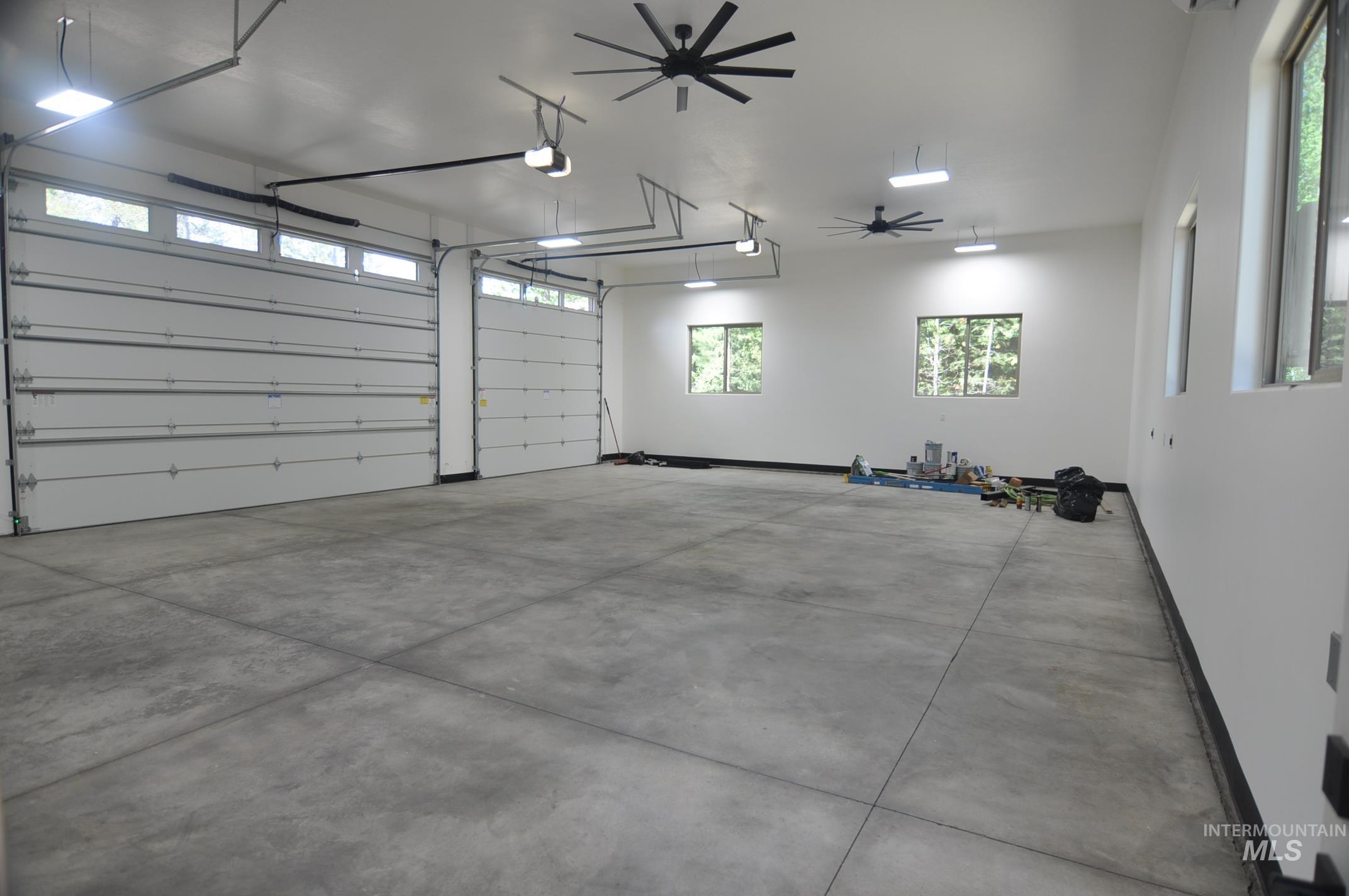 Massive 1600 sq ft garage has a set of 12' by 14' doors, a dedicated mini split, man door to the back yard and will fit a fleet of toys.