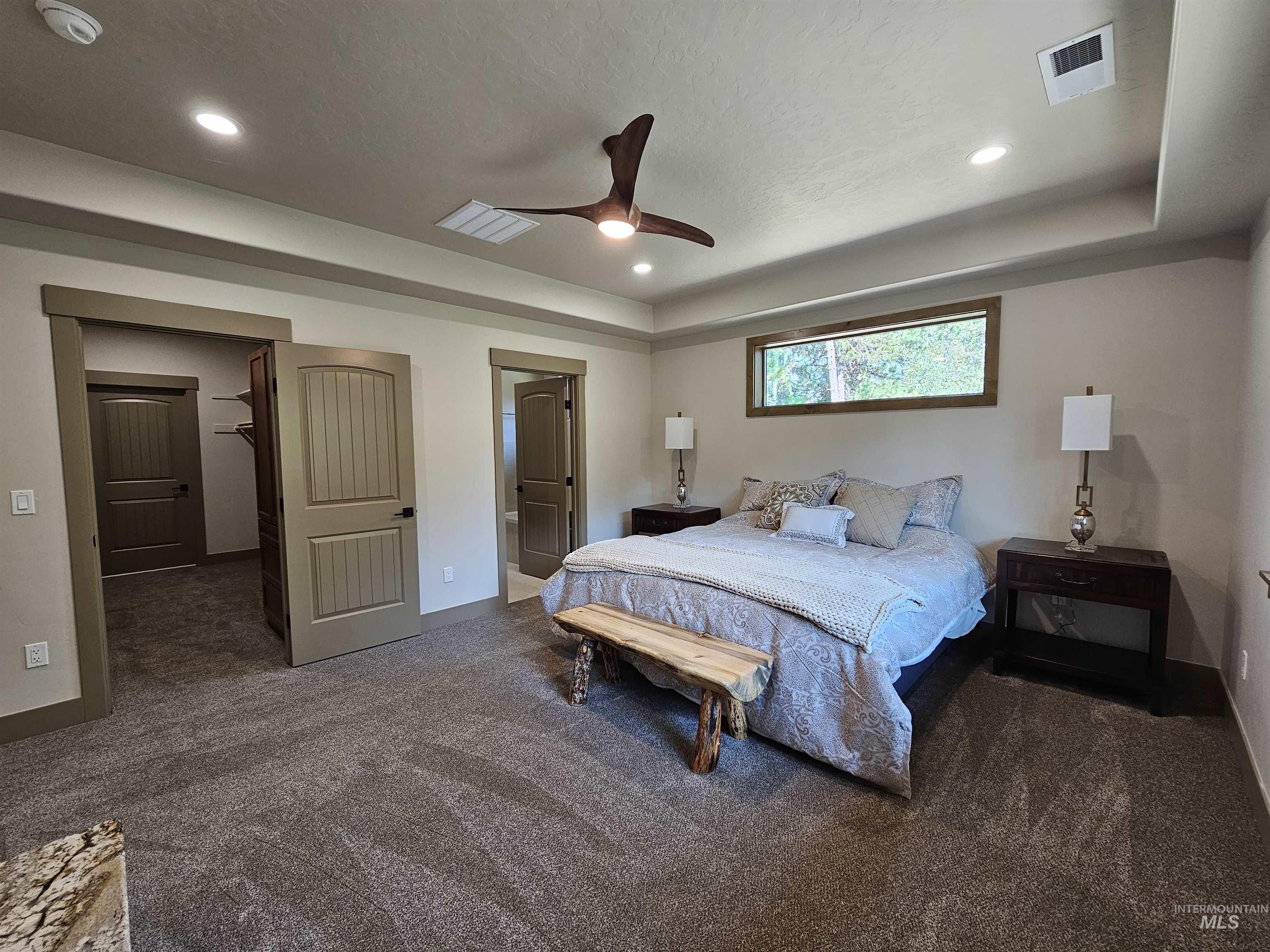 Primary bedroom with ensuite bath, walk in closet.