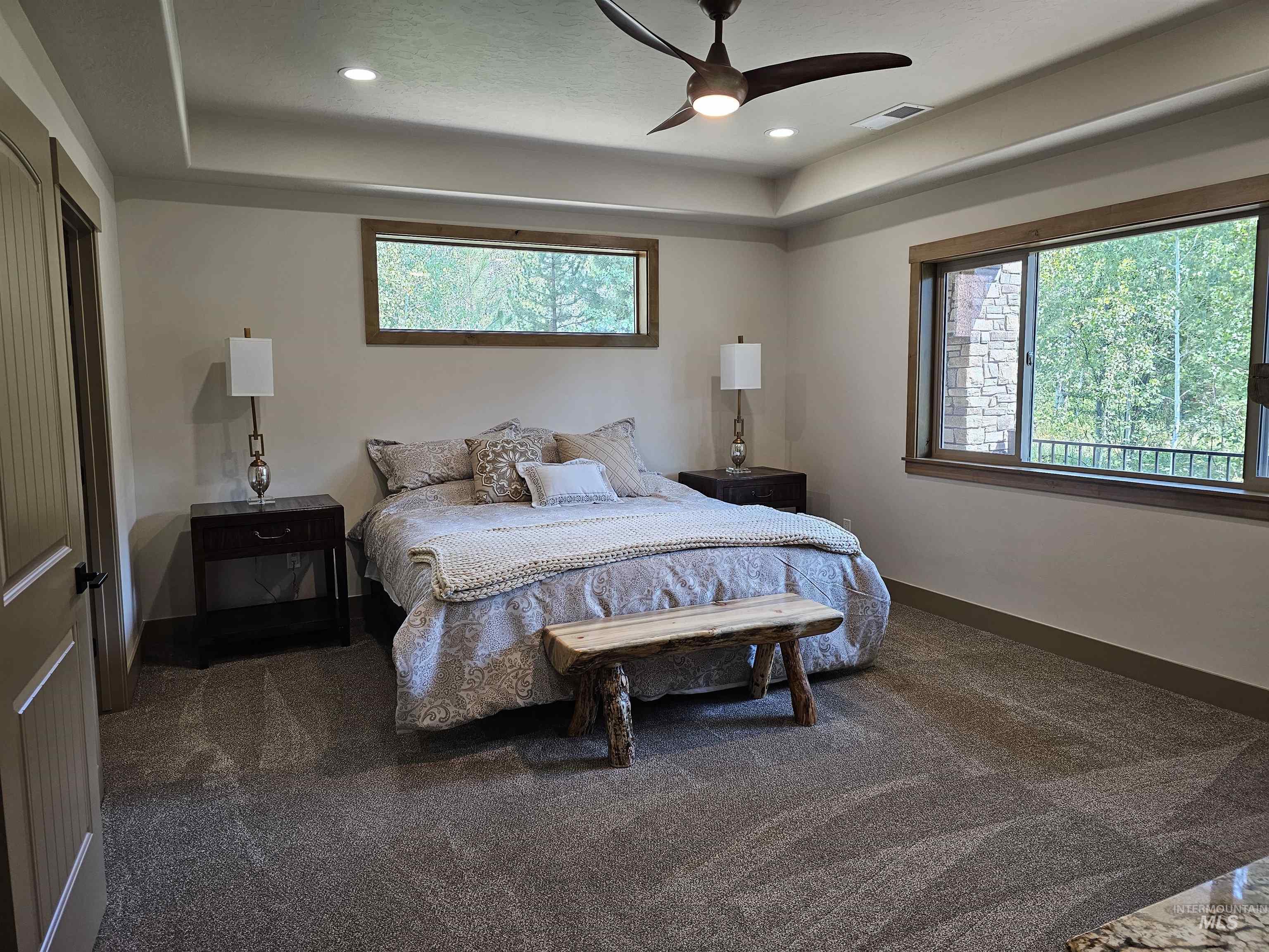 Carpeted bedroom with recessed lighting, coffered ceiling and ceiling fan.
