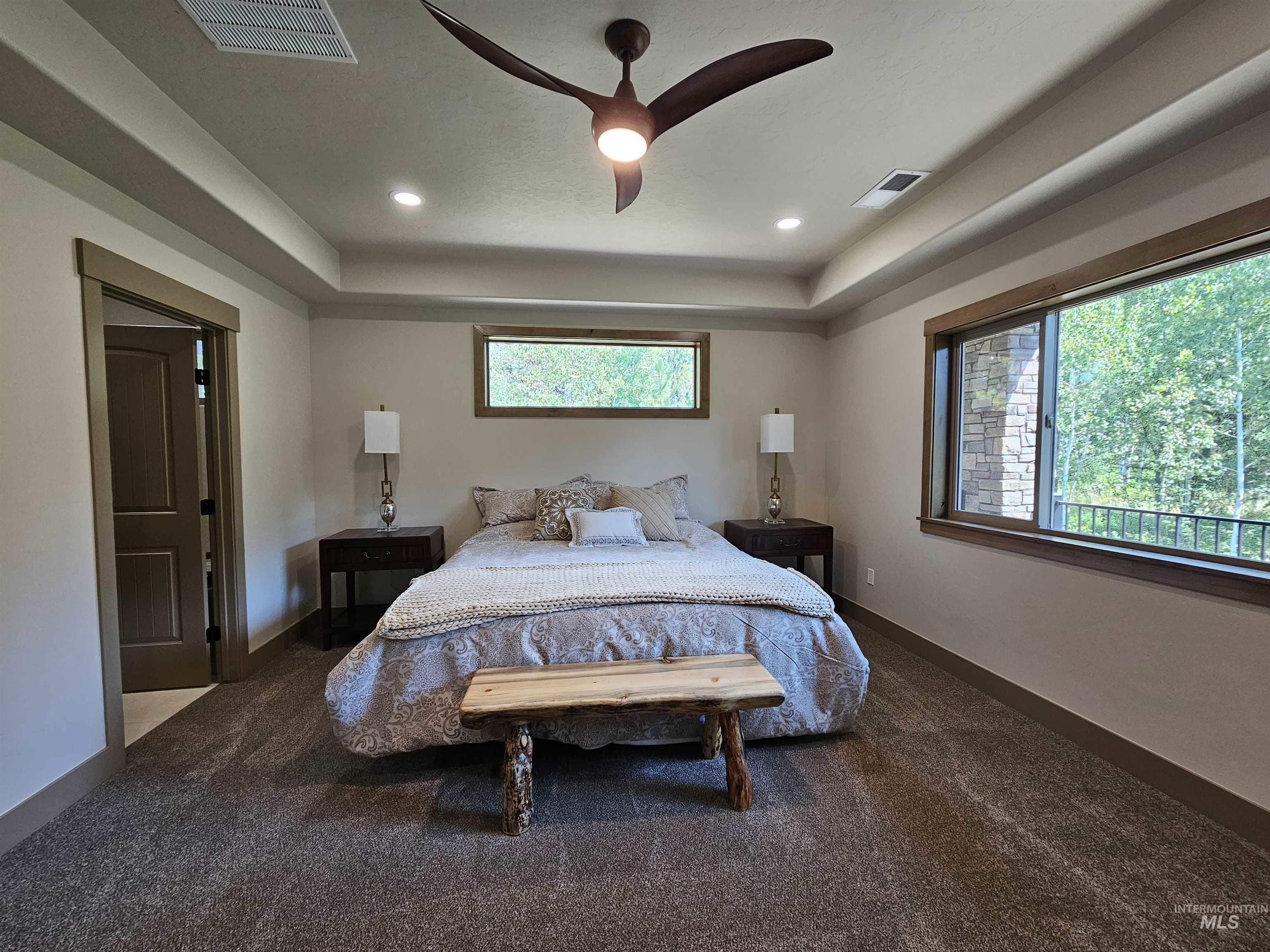 Large primary bedroom fits a king size bed with room to spare and the large picture window brings the outdoors in.