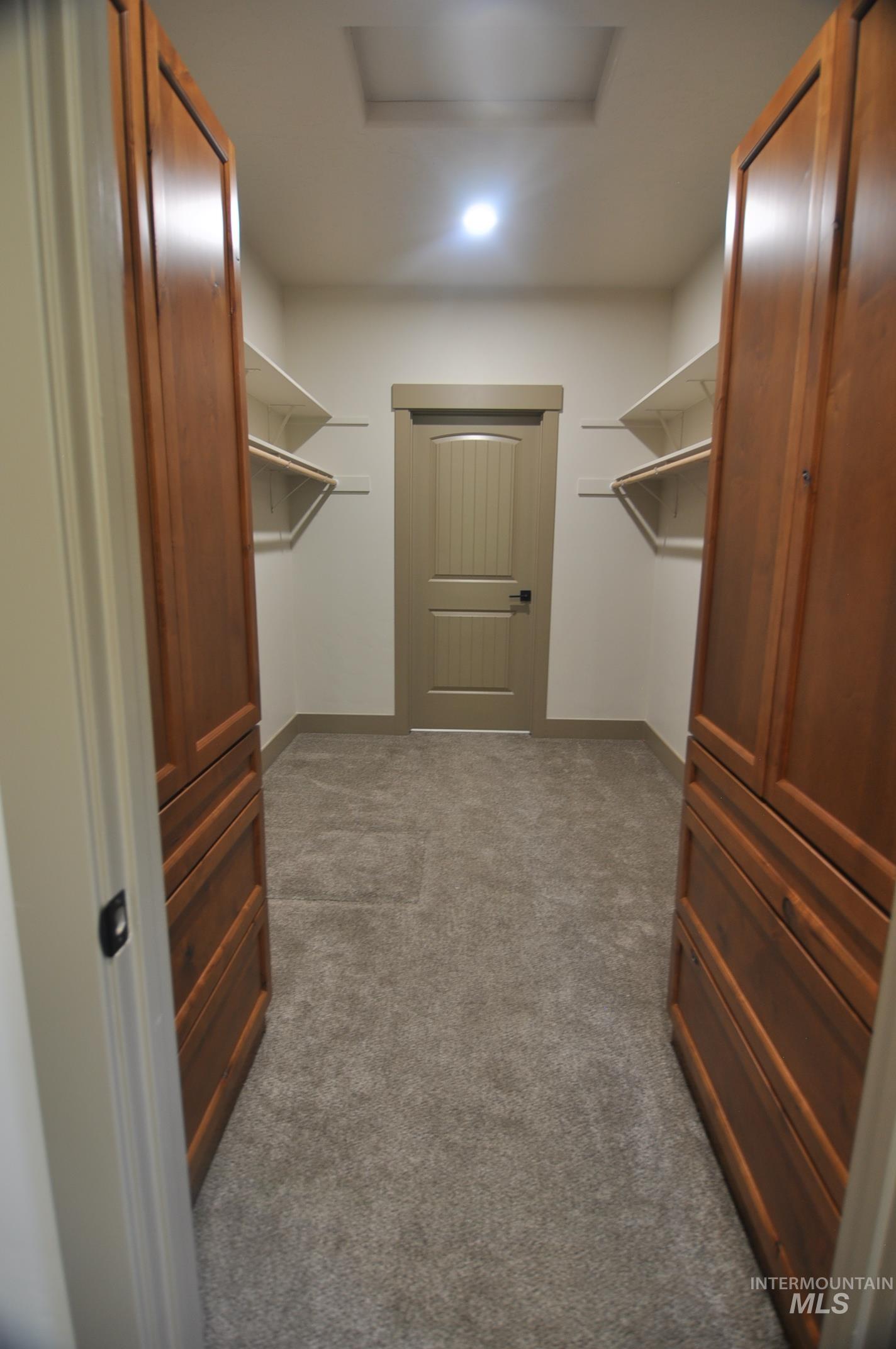 Great walk in closet in primary bedroom. Two large alder cabinets for storage and access right into the laundry room.