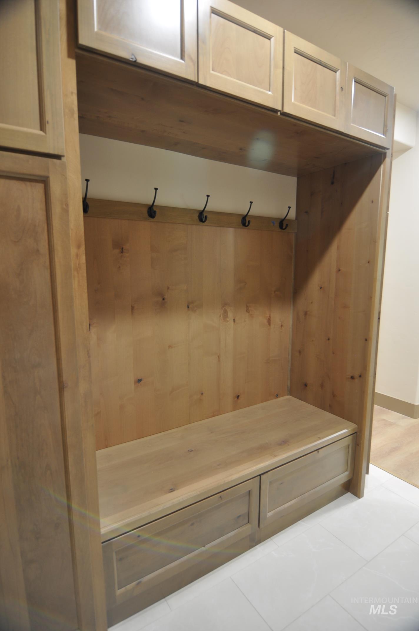 Alder storage cabinet, drawers and bench seating in mudroom. A great place to kick your shoes off!