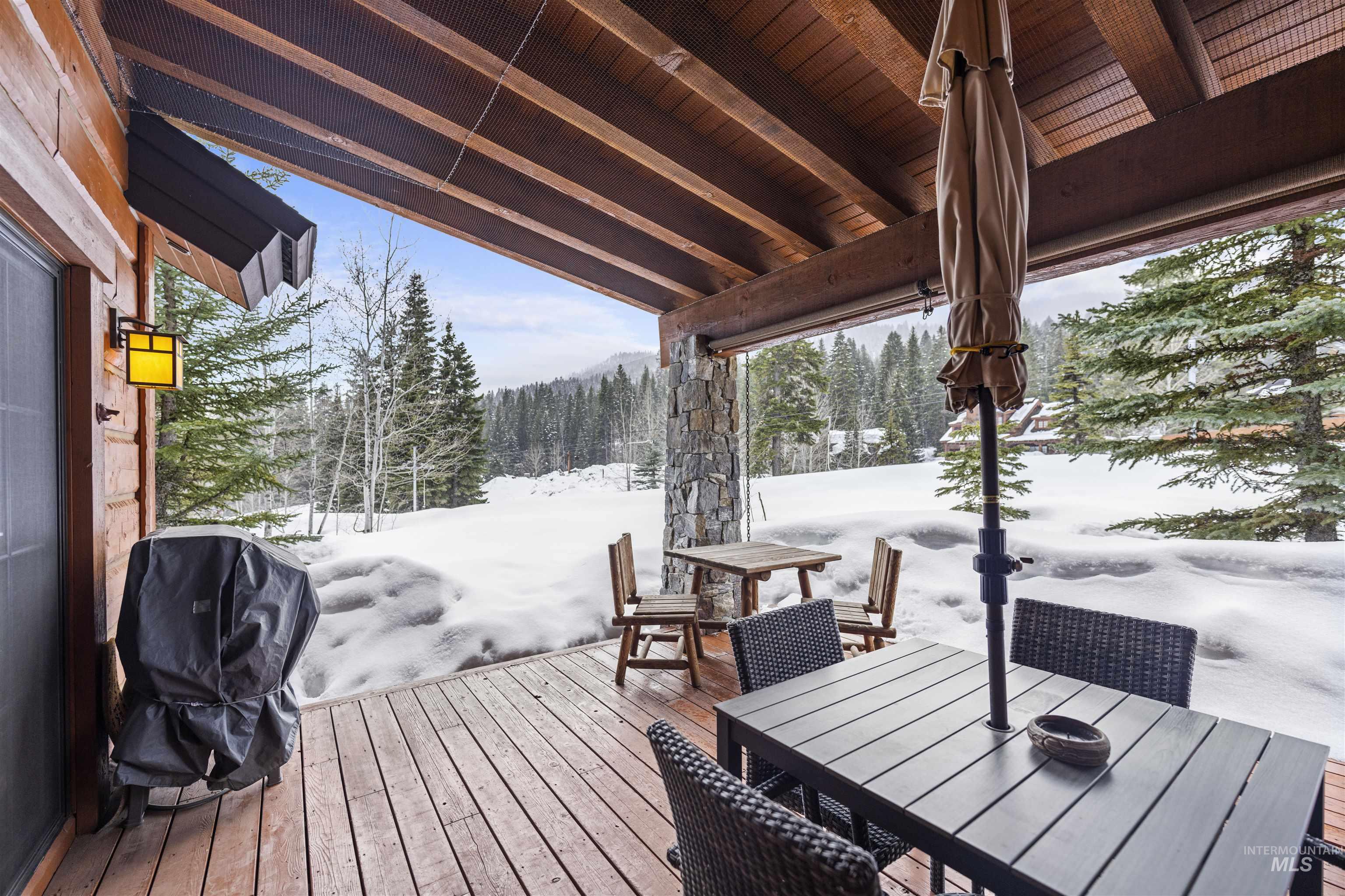Snow covered deck with outdoor dining space