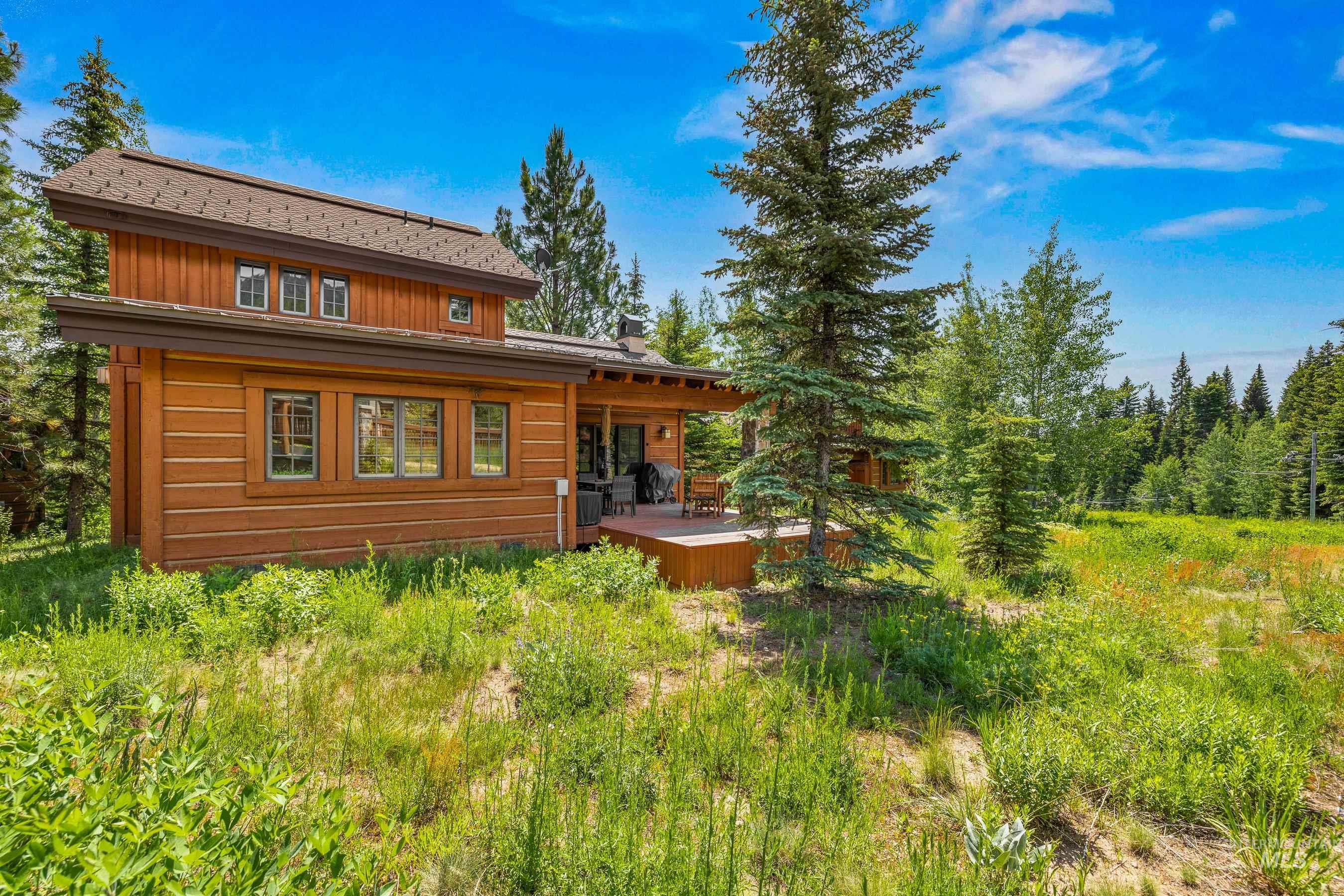Rear view of house with a deck and board and batten siding