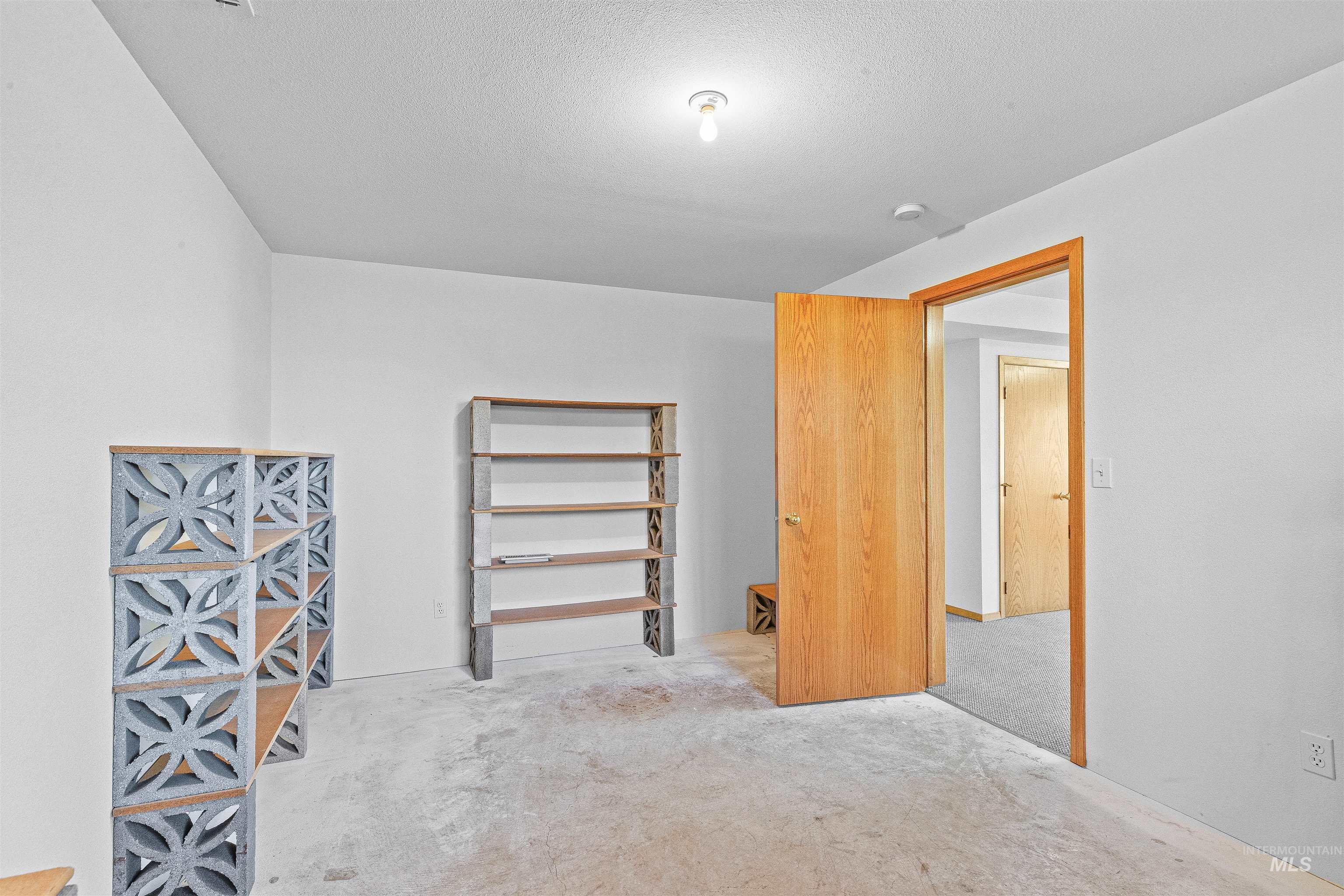 Unfurnished bedroom with carpet and a textured ceiling