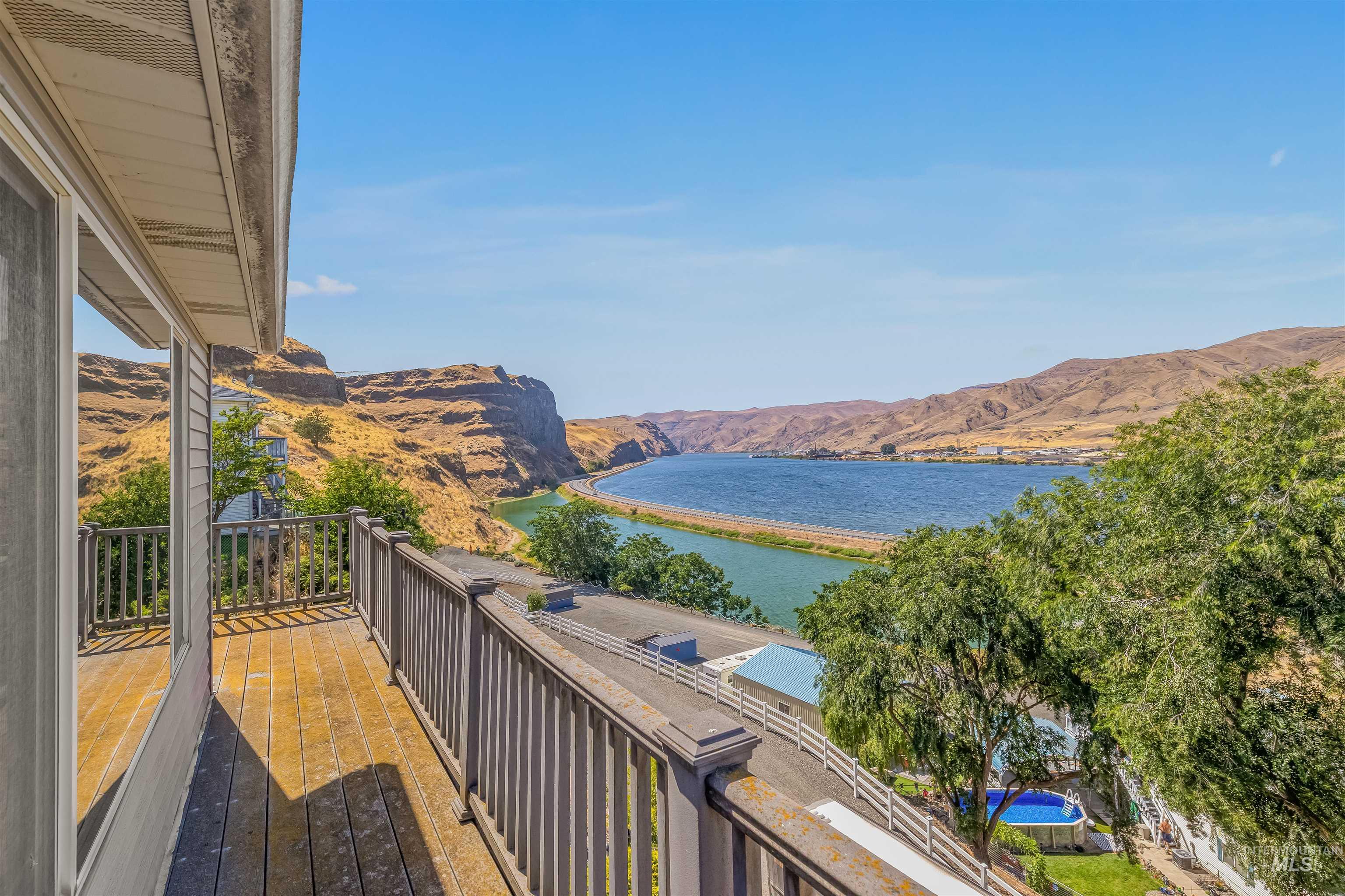 Balcony featuring a water and mountain view