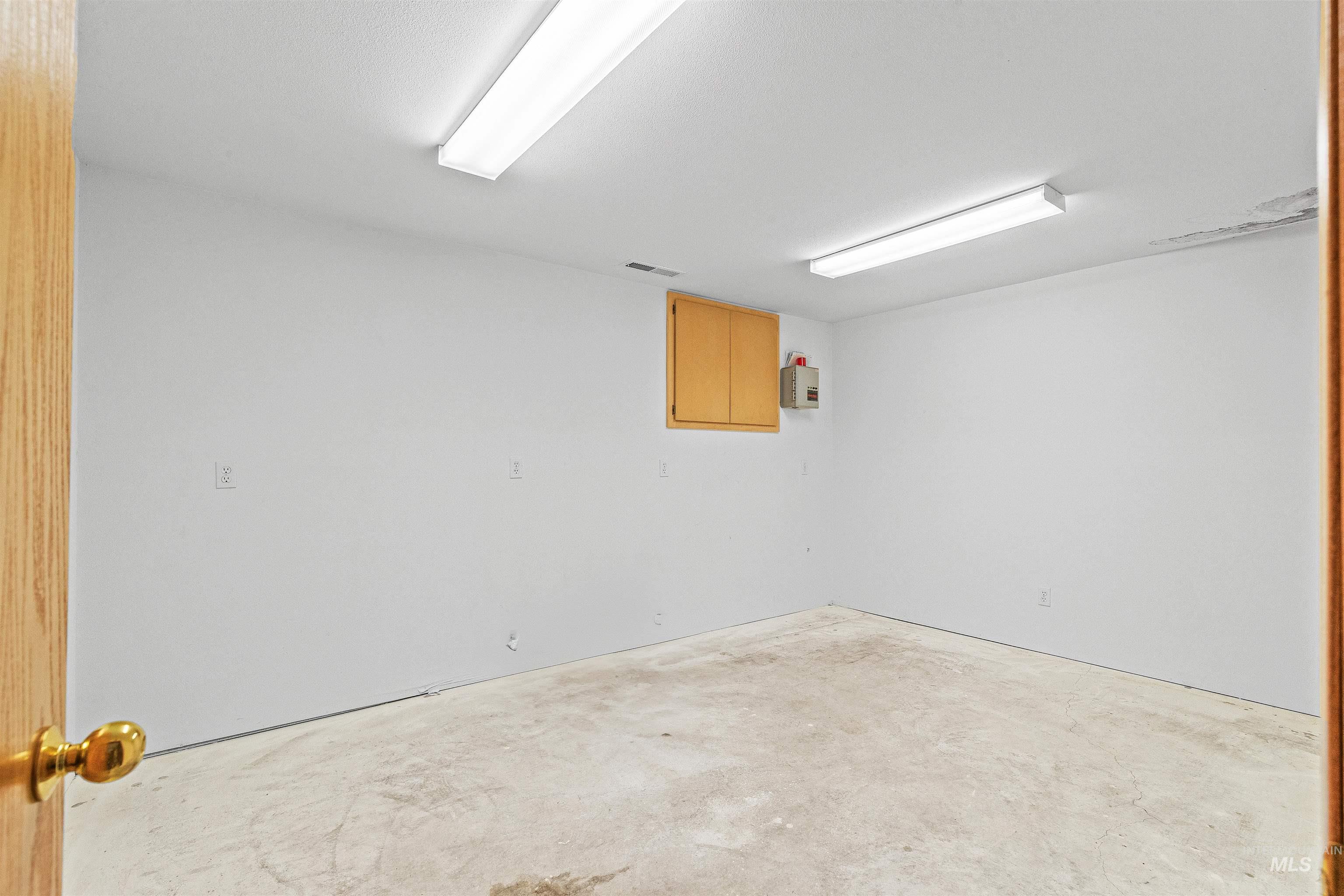 Empty room with unfinished concrete floors