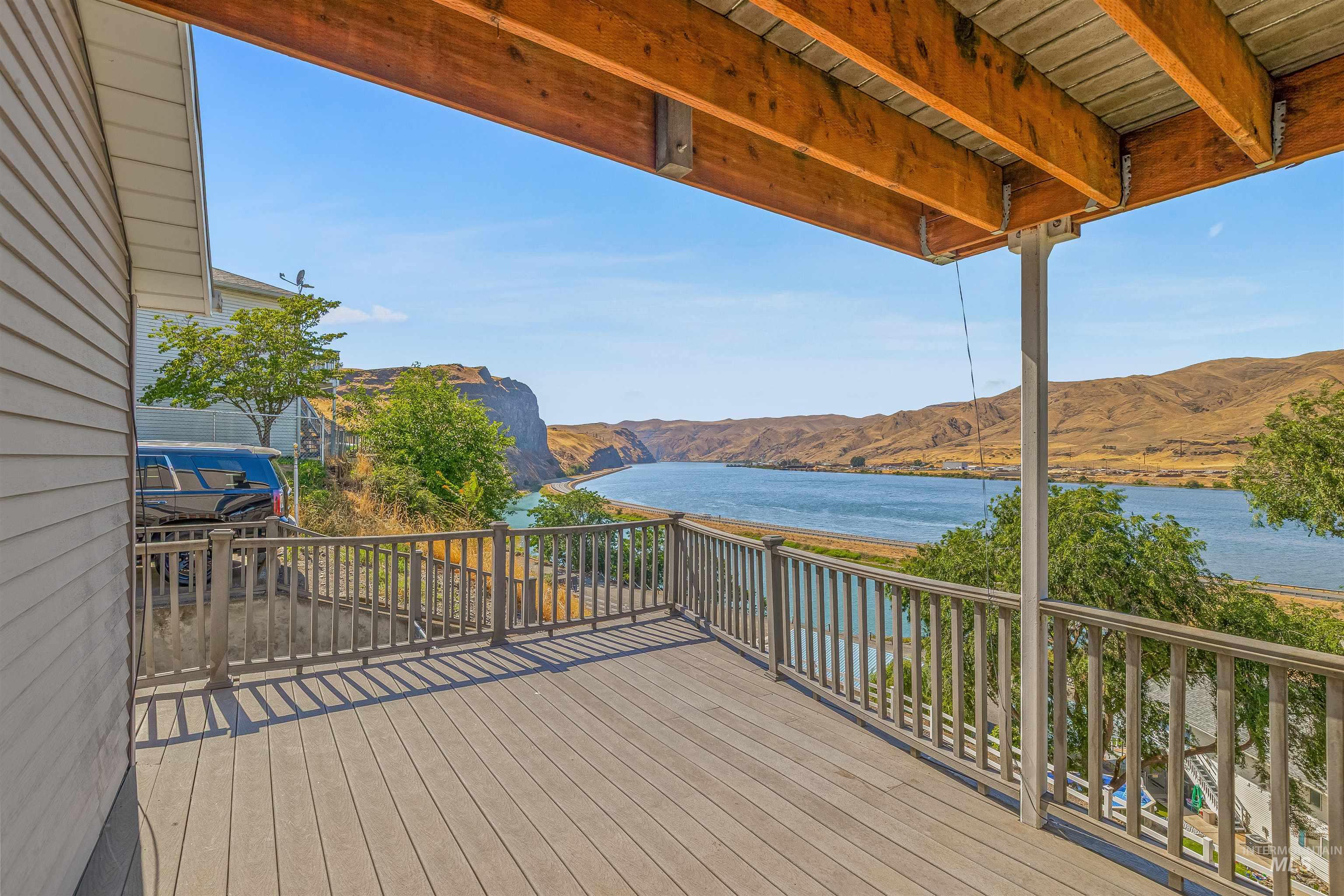 Deck with a water and mountain view