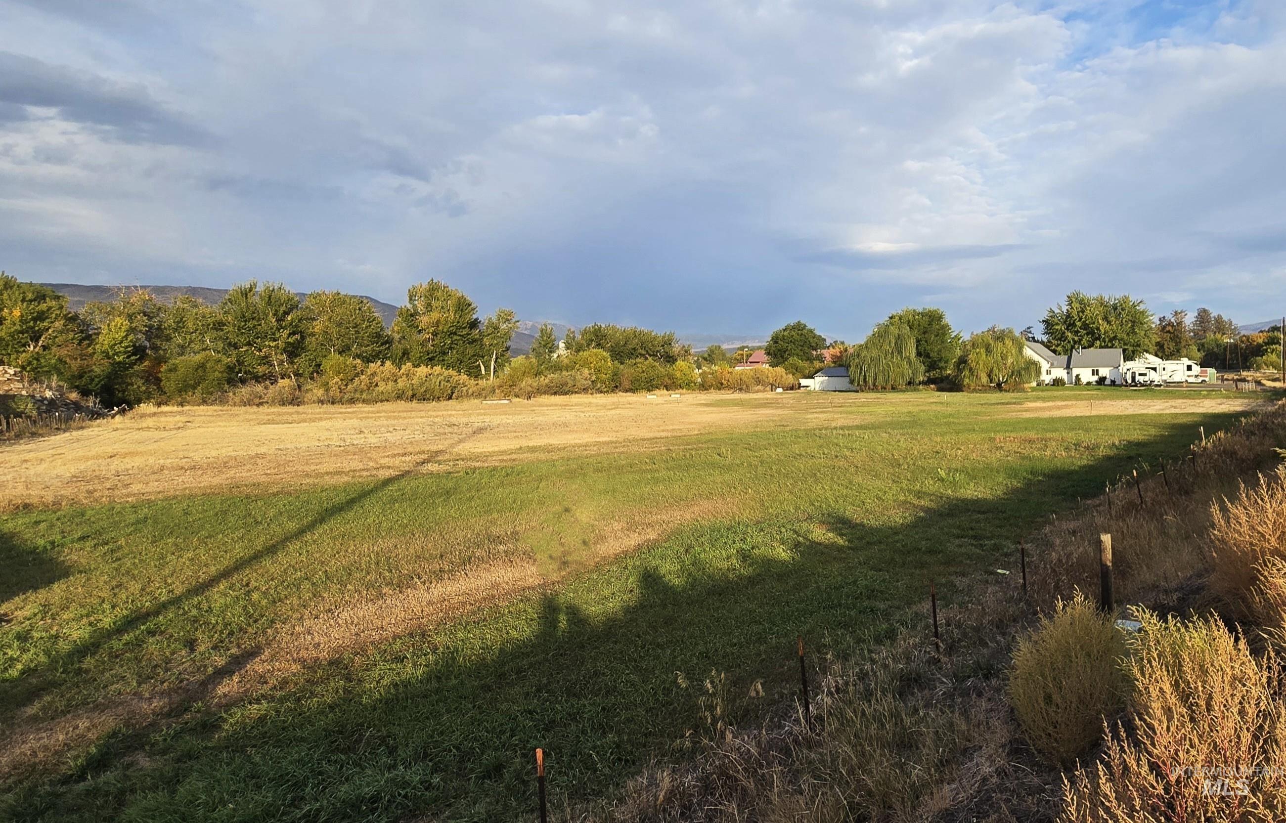 View of community with a lawn and a view of rural / pastoral area