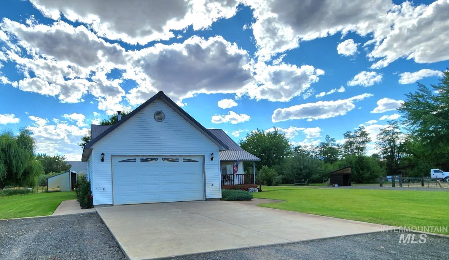Two story home with a front yard, driveway, and an attached garage
