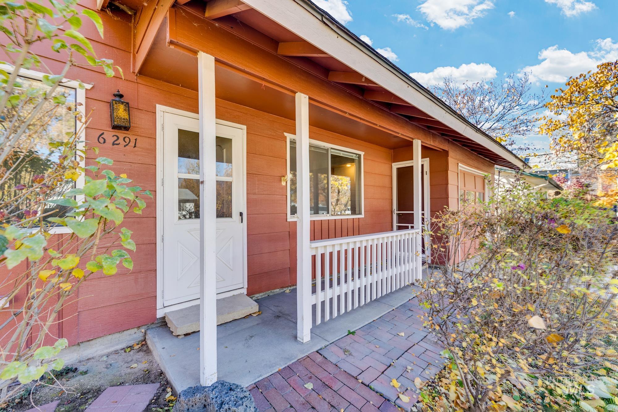 View of exterior entry featuring covered porch