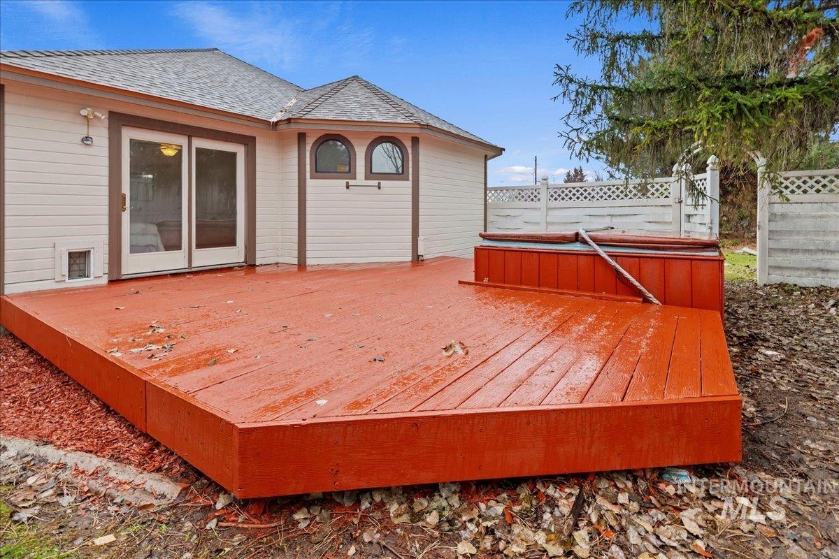 Wooden deck featuring a hot tub
