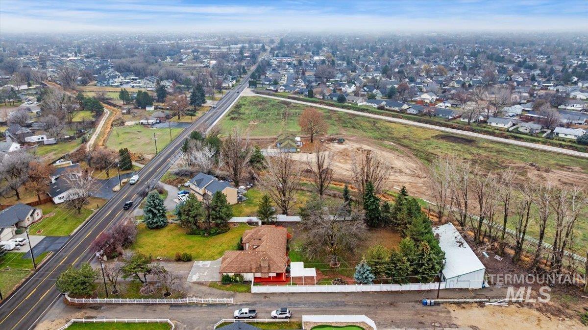 Aerial view of property's location with nearby suburban area