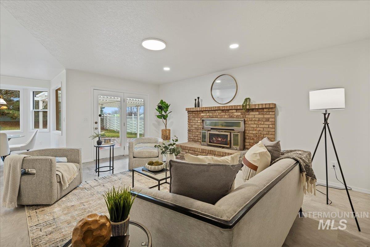 Living area featuring a brick fireplace and a textured ceiling